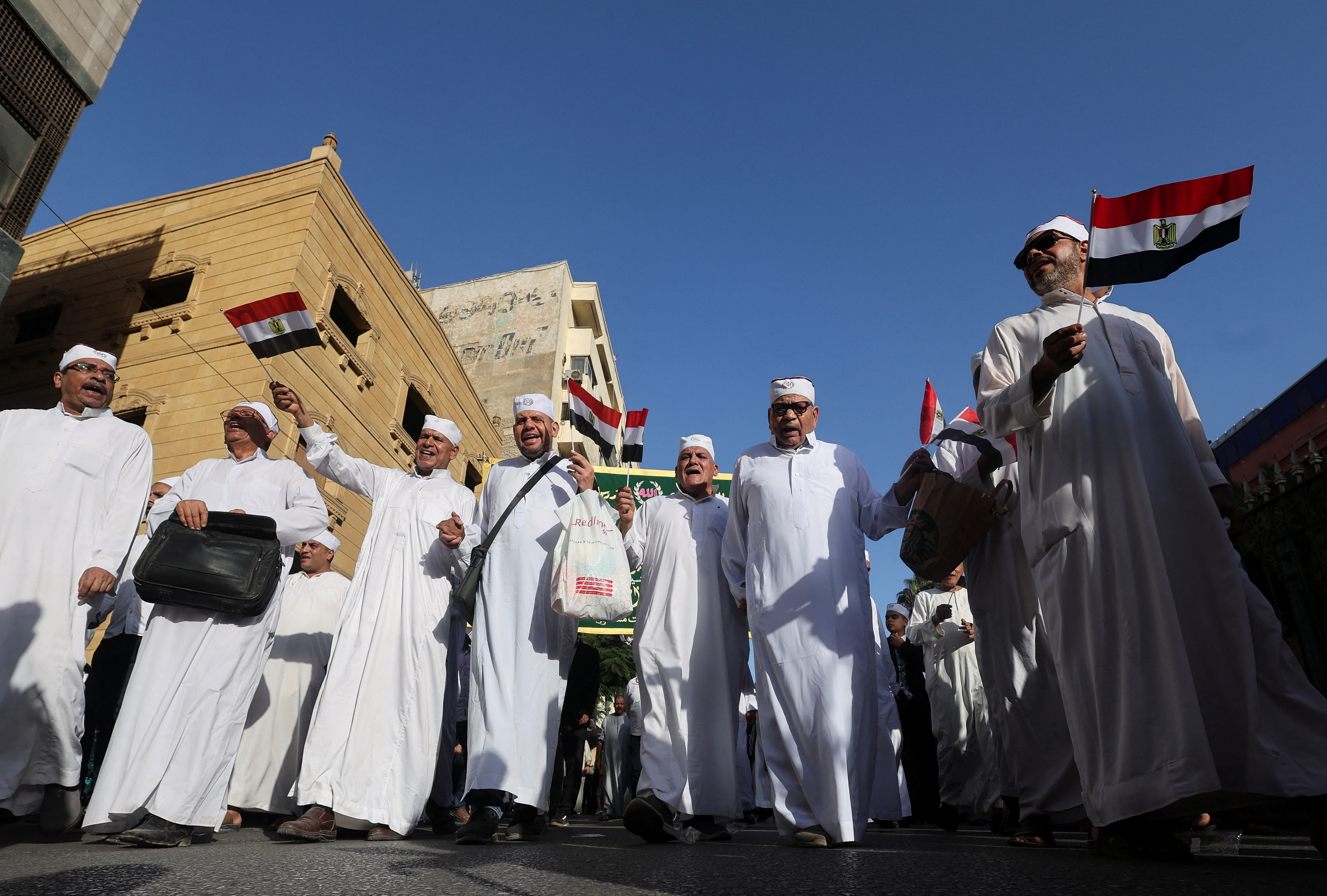 Sufi Muslims carrying Egyptian national flags march to celebrate "Mawlid al-Nabawi", or the birth of Prophet Mohammad, in Al Azhar district, Old Cairo, Egypt, September 27, 2023. REUTERS/Amr Abdallah Dalsh