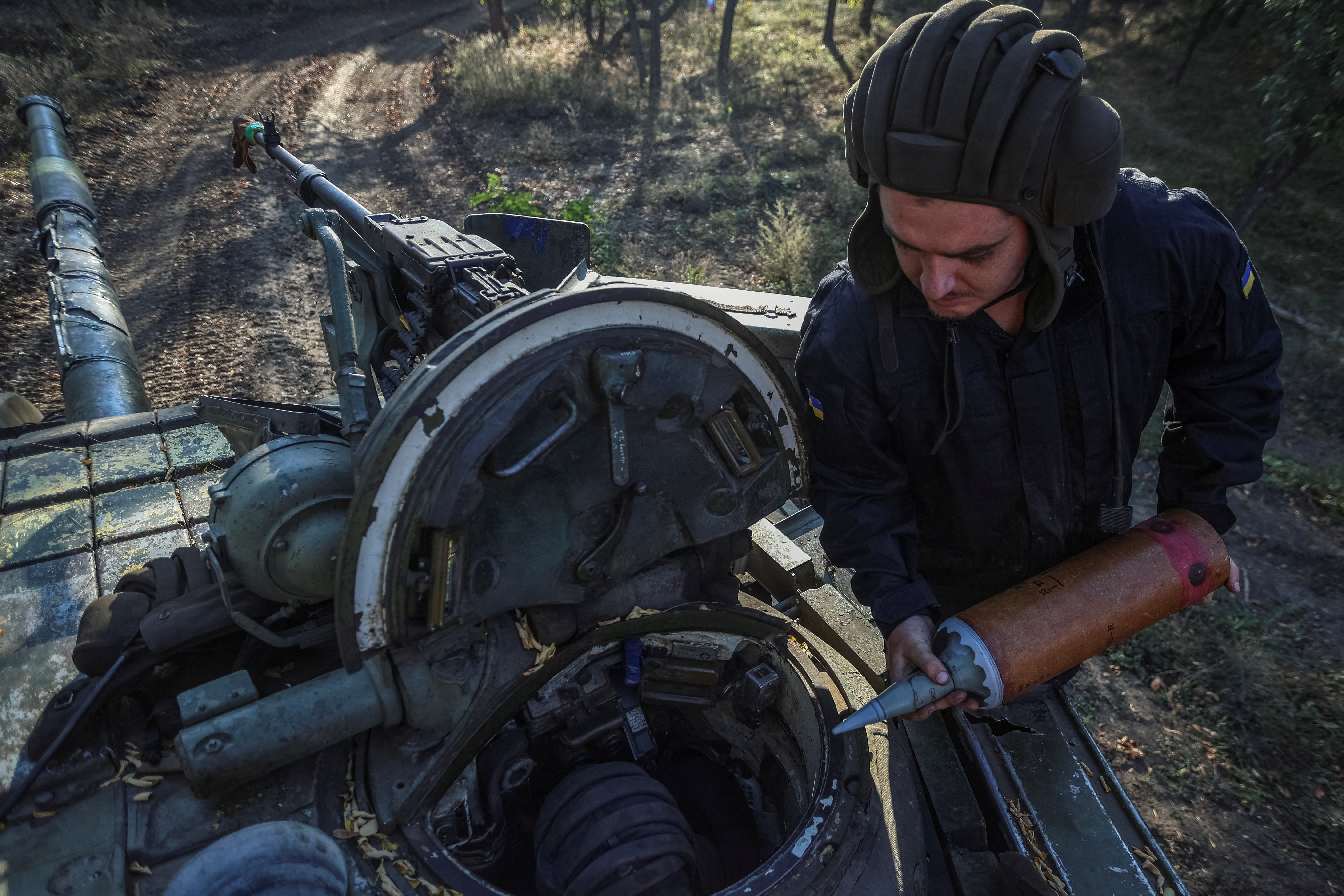 A Ukrainian soldier loading shells into a tank