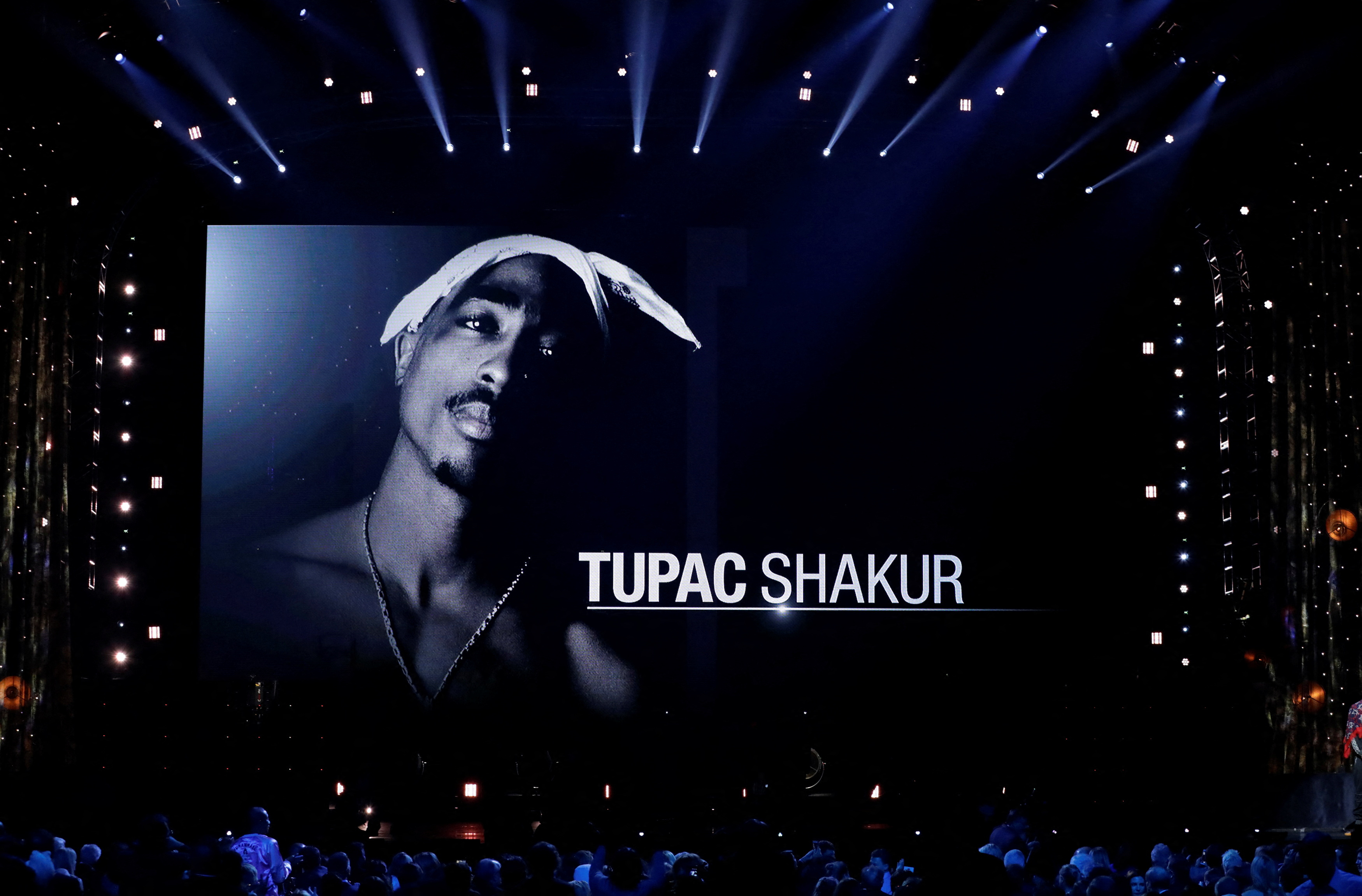 Screen shows photo of Tupac Shakur