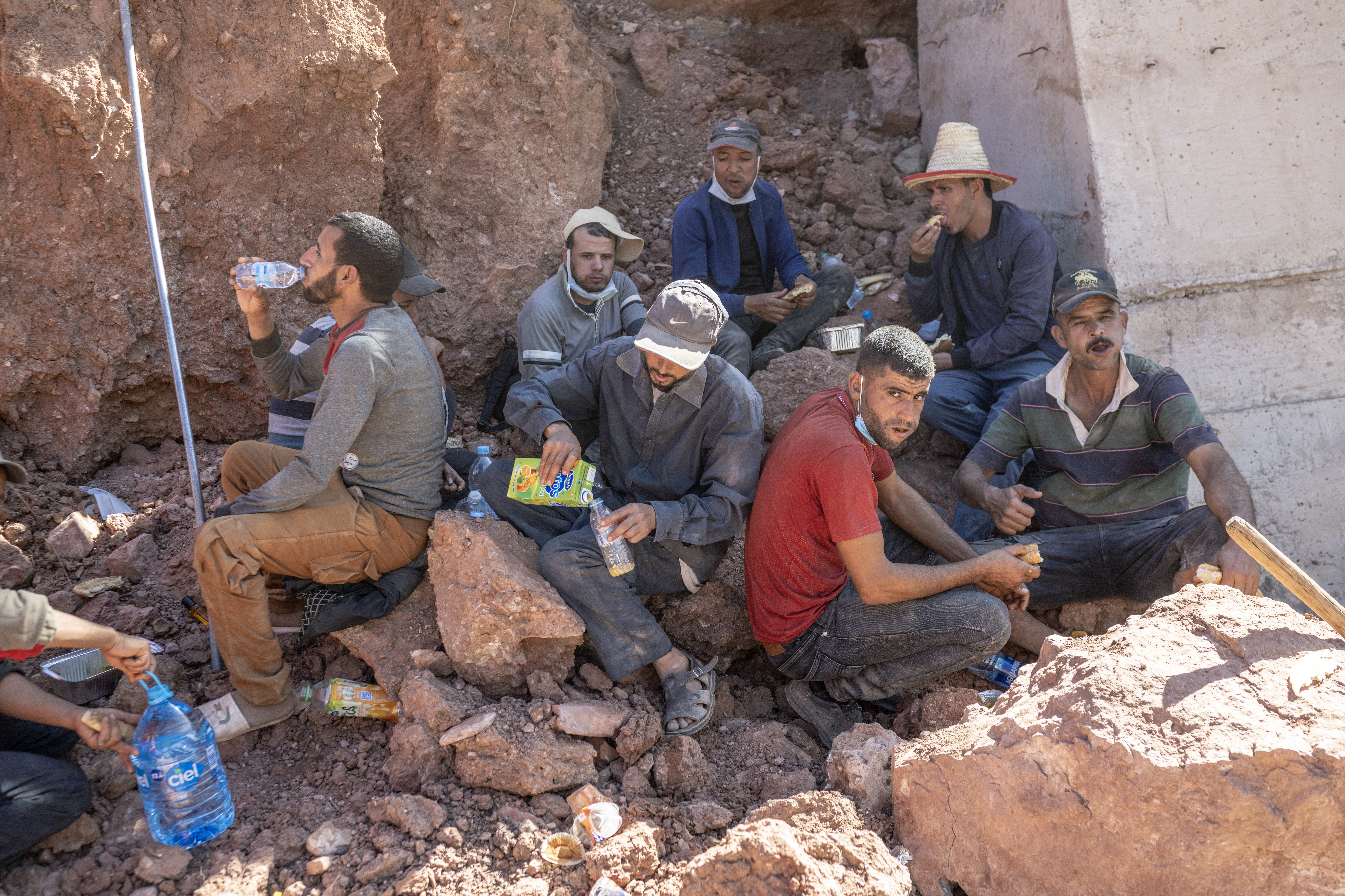 Workers rest at the site of rescue operations in the mountainous area of Tizi N'Test, in the Taroudant province, one of the most devastated in quake-hit Morocco
