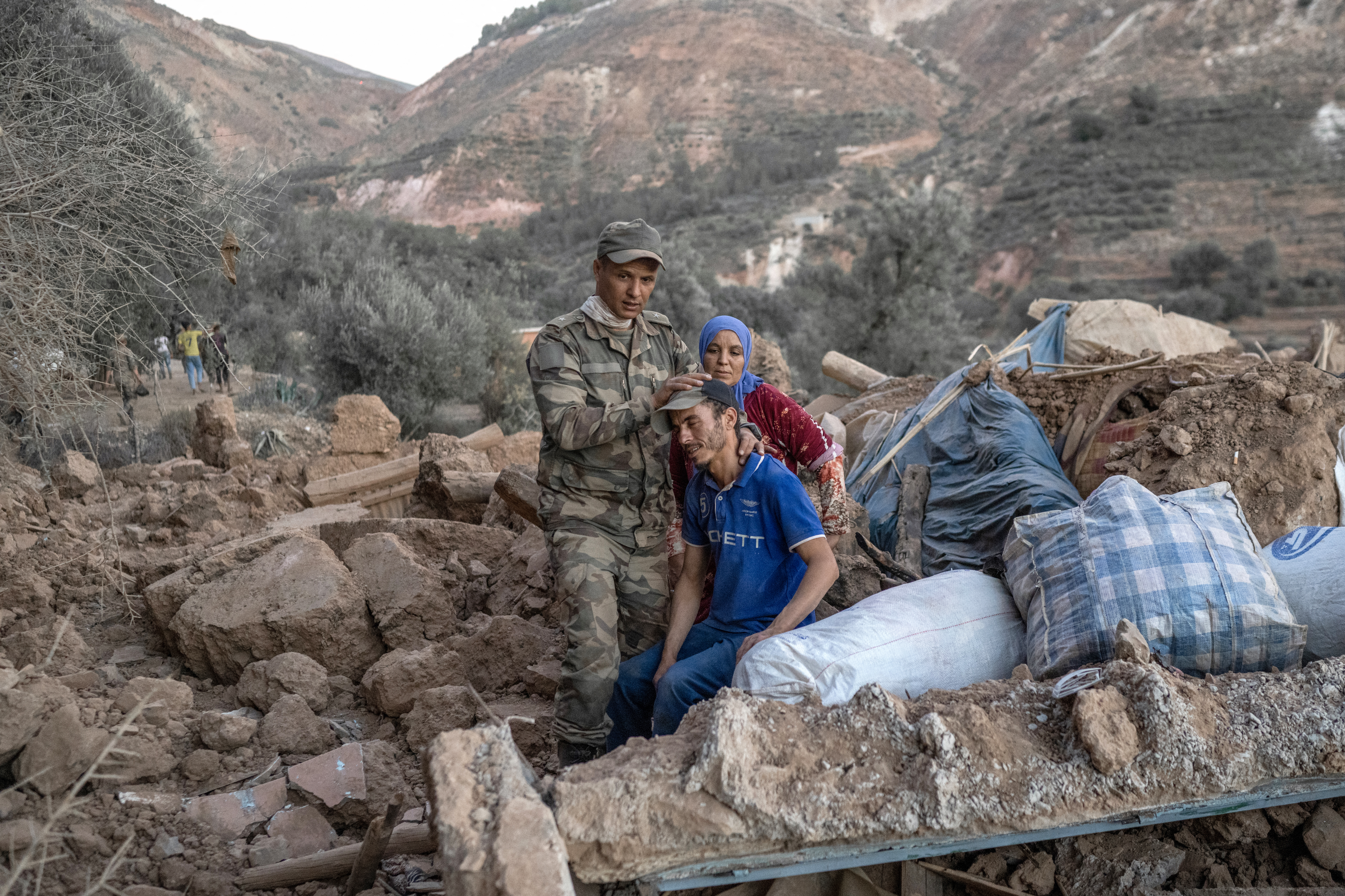 A Moroccan soldier comforts a man sitting on rubble in the mountainous area of Tizi N'Test, in the Taroudant province, one of the most devastated in quake-hit Morocco