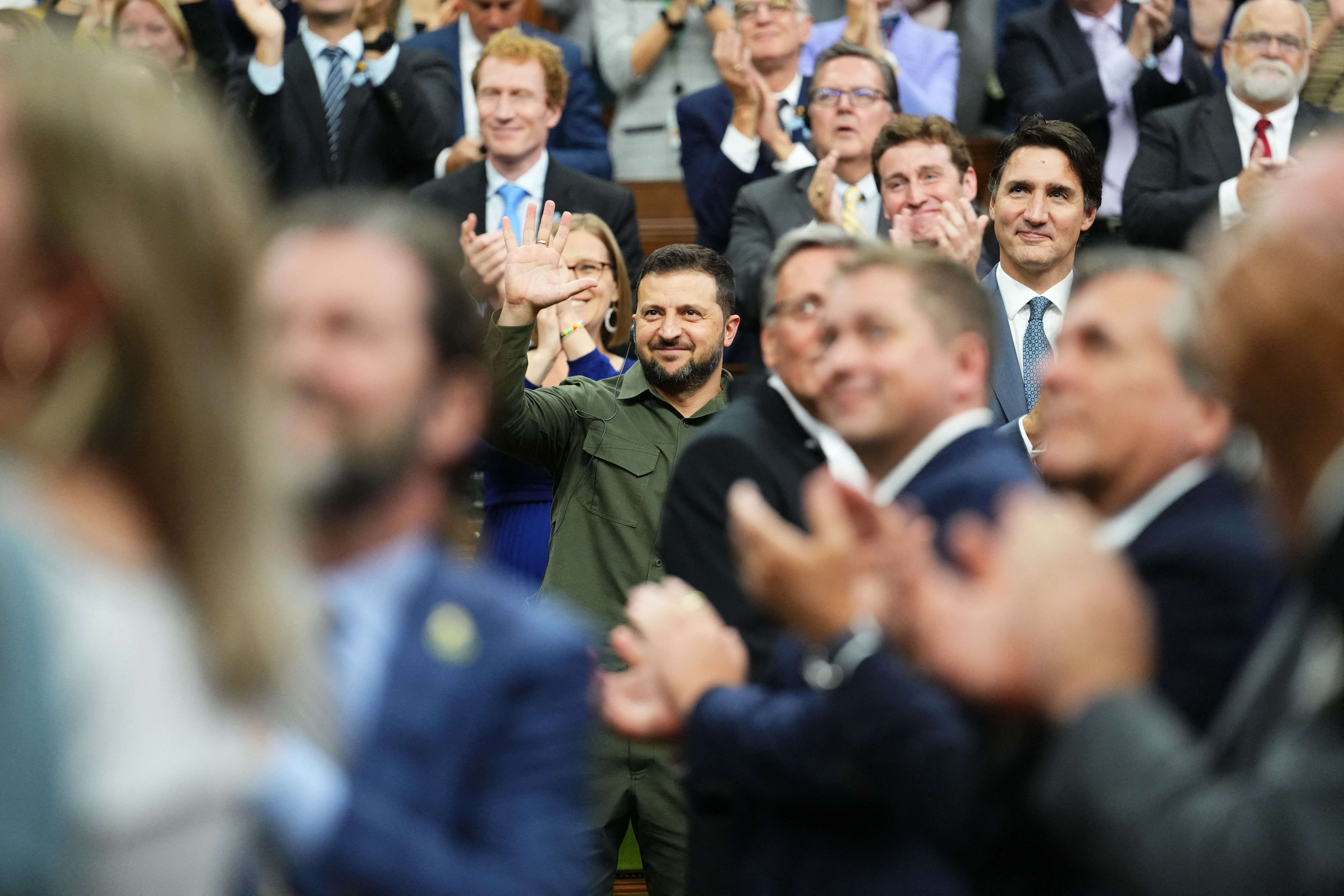 Ukrainian President Volodymyr Zelensky (C) with Canadian Prime Minister Justin Trudeau (R), acknowdledges a Canadian-Ukrainian war veteran after addressing the House of Commons in Ottawa, Canada, on September 22, 2023. (Photo by Sean Kilpatrick / POOL / AFP)