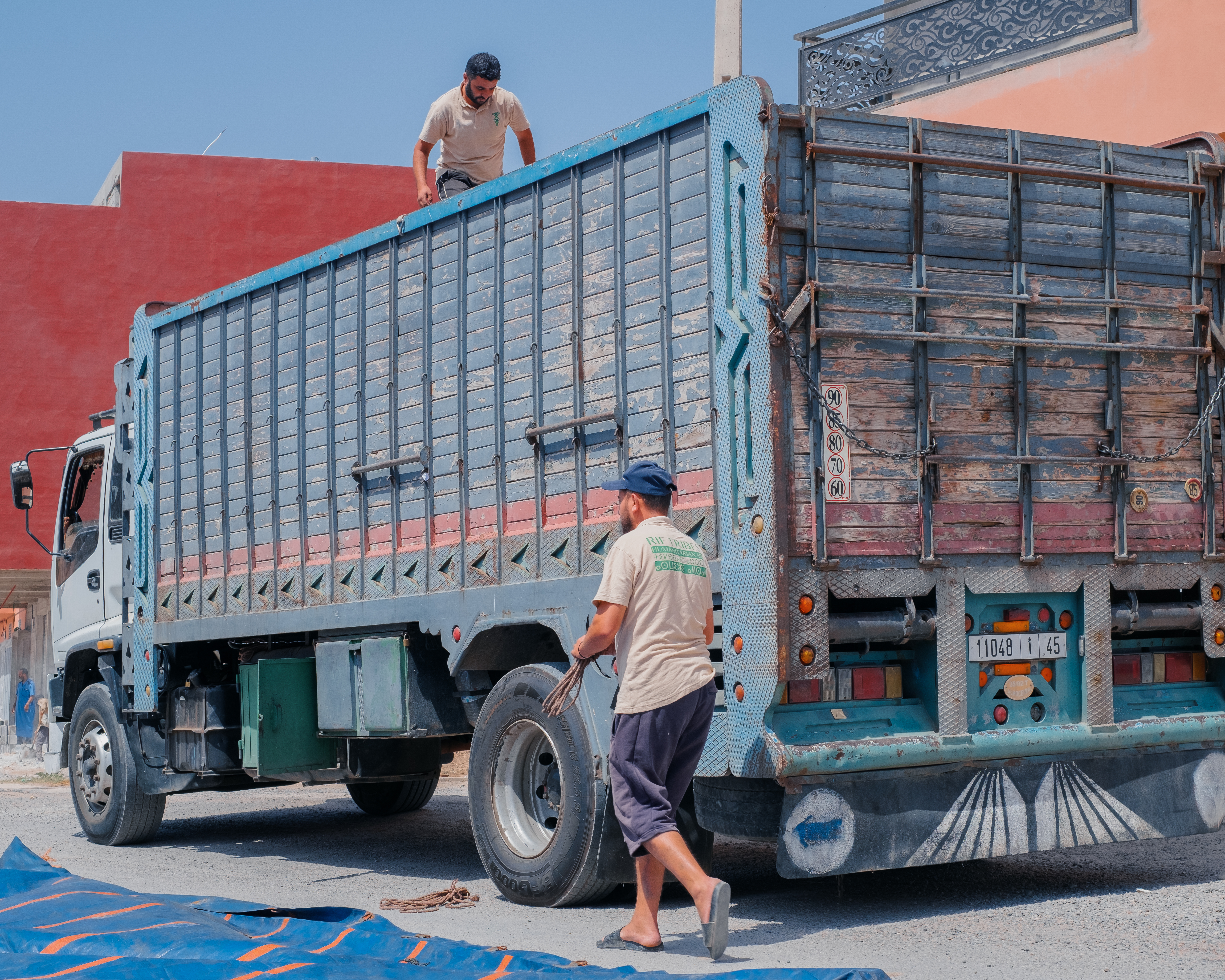 Rif Tribes Foundation volunteers distributing supplies in the village of Aït Si Allal [Bianca CARRERA ESPRIU/Al Jazeera]