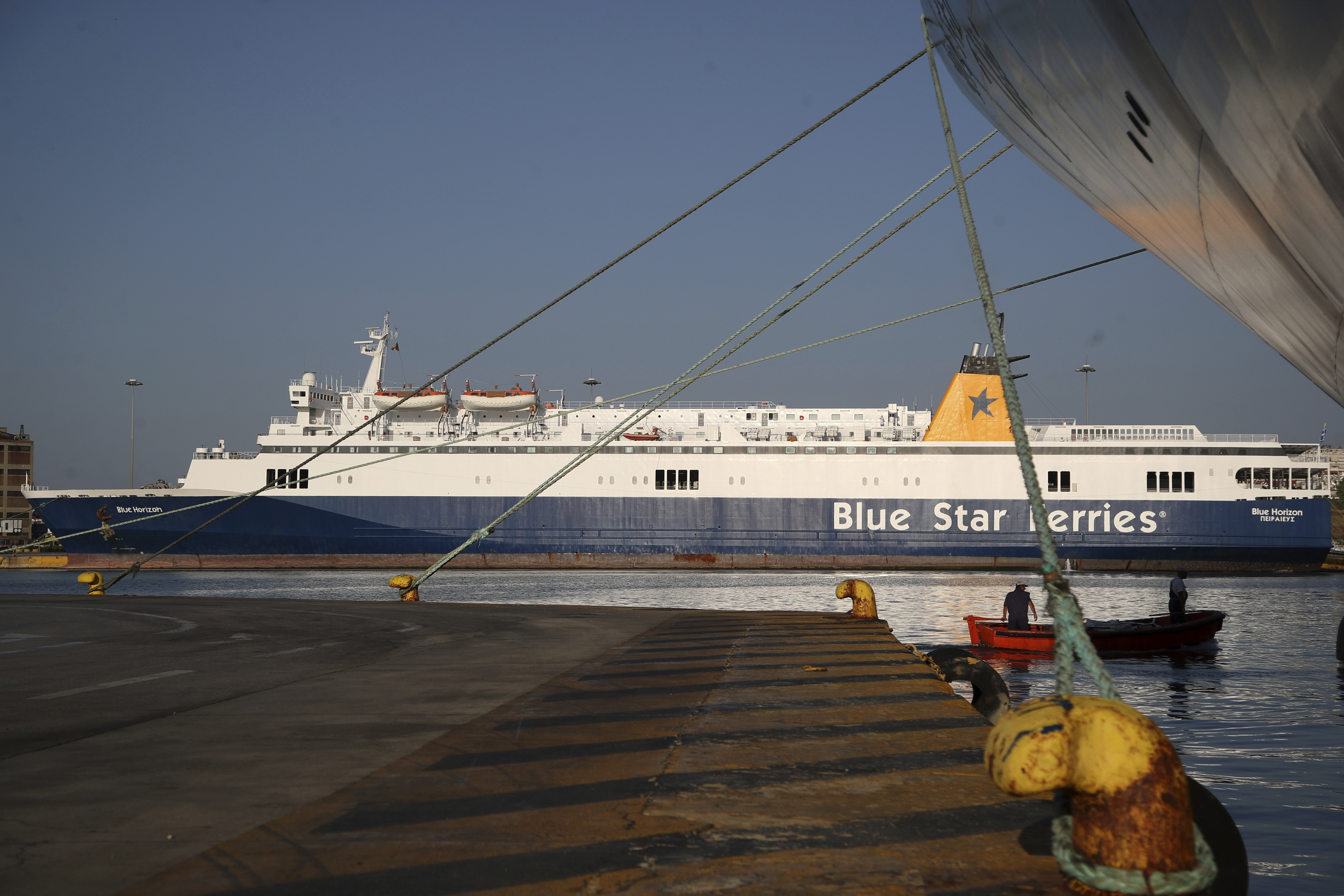 FILE - The ferry boat Blue Horizon is docked during seamen's unions strike at the port of Piraeus, near Athens on Sept. 3, 2018. A Greek island ferry captain and three of his crew faced homicide charges on Wednesday, Sept. 6, 2023, over the death of a late passenger who was pushed by crew members into the sea as he tried to force his way onto the departing Blue Horizon in the country's main port of Piraeus. (AP Photo/Thanassis Stavrakis, File)