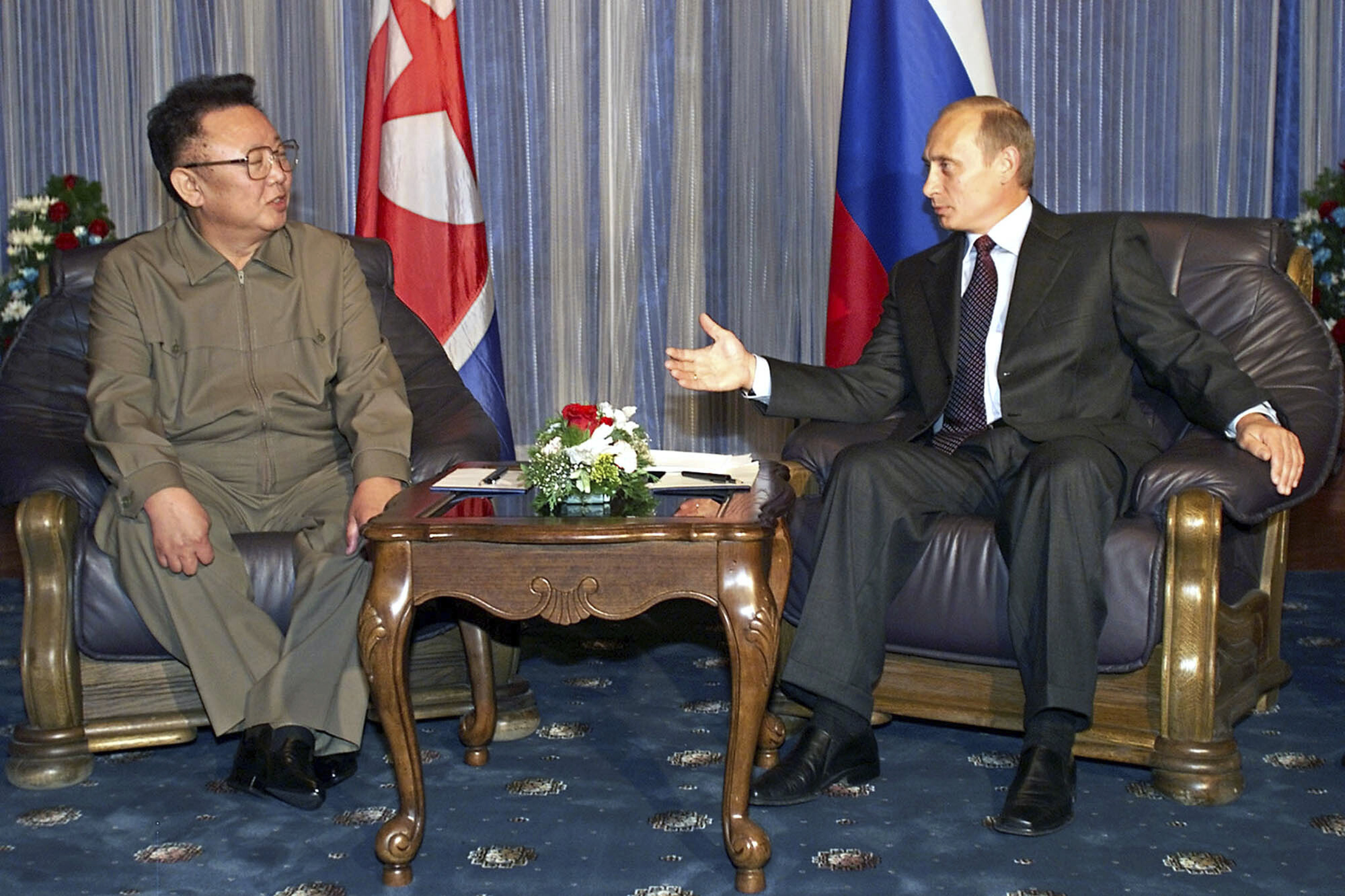 Russian President Vladimir Putin gestures as he talks to North Korean then-leader Kim Jong Il during their meeting in Vladivostok, Russia, on August 23, 2002.
