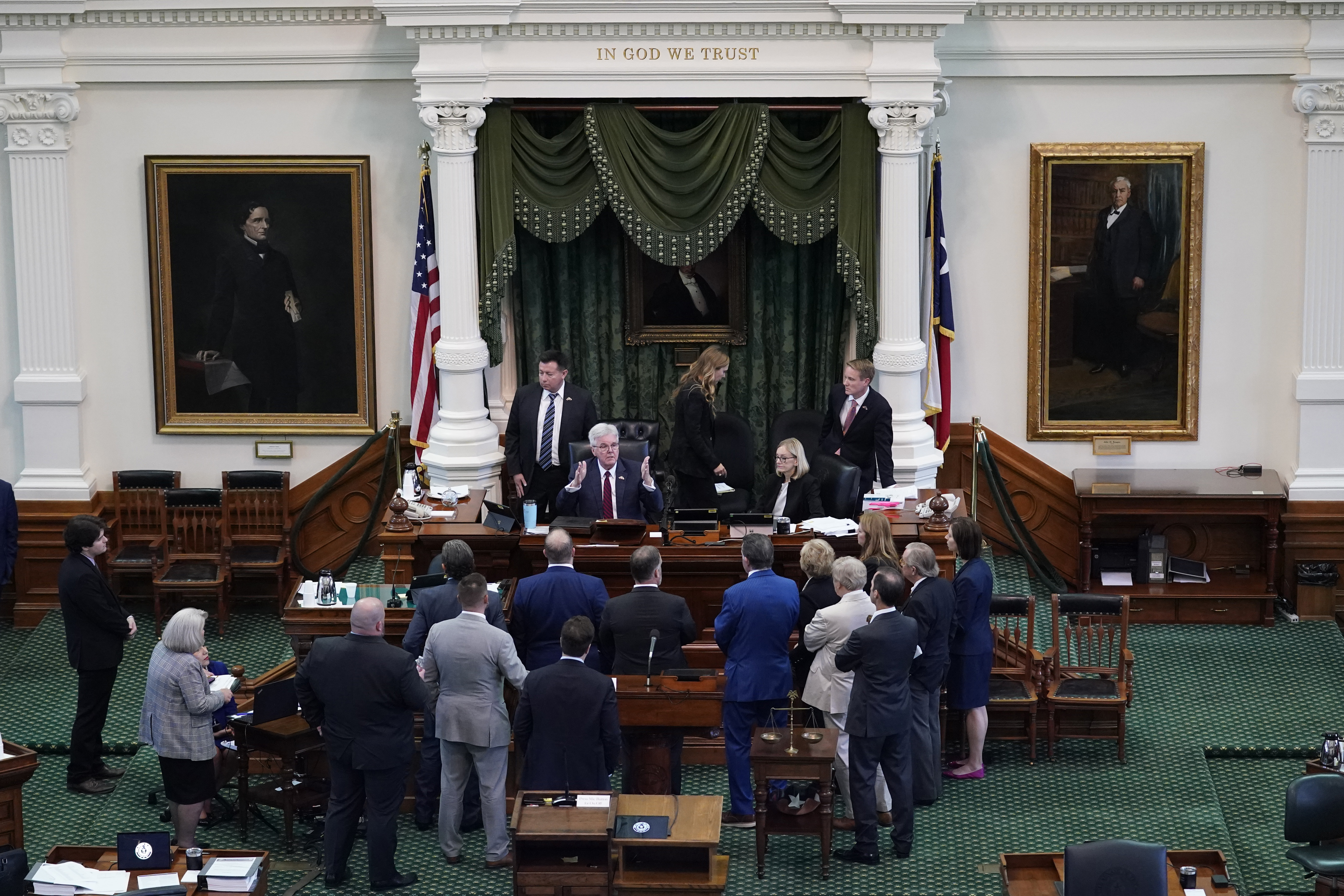 Texas Lieutenant Governor Dan Patrick talks to prosecution and defense attorneys after the prosecution rested in the impeachment trial for Texas Attorney General Ken Paxton in the Senate Chamber at the Texas Capitol, Wednesday, Sept. 13, 2023, in Austin, Texas.