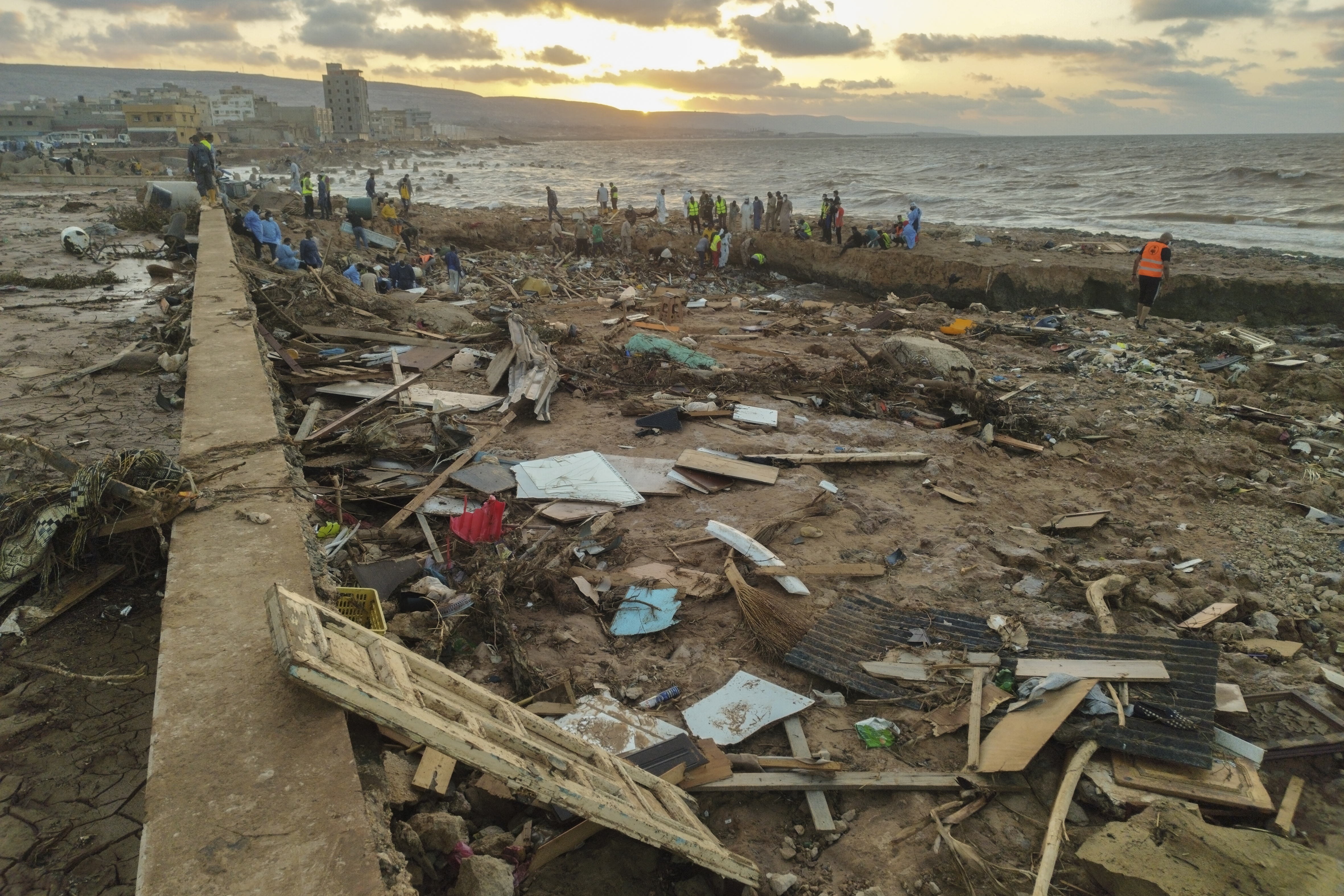 Rescuers and relatives search for bodies of the flood victims at the Corniche of the city of Derna, Libya