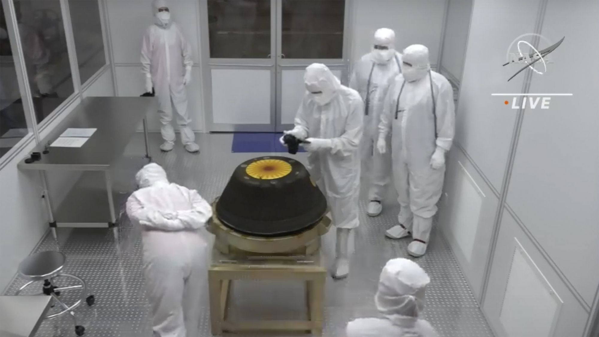 Technicians in a clean room examine the OSIRIS-REx sample return capsule