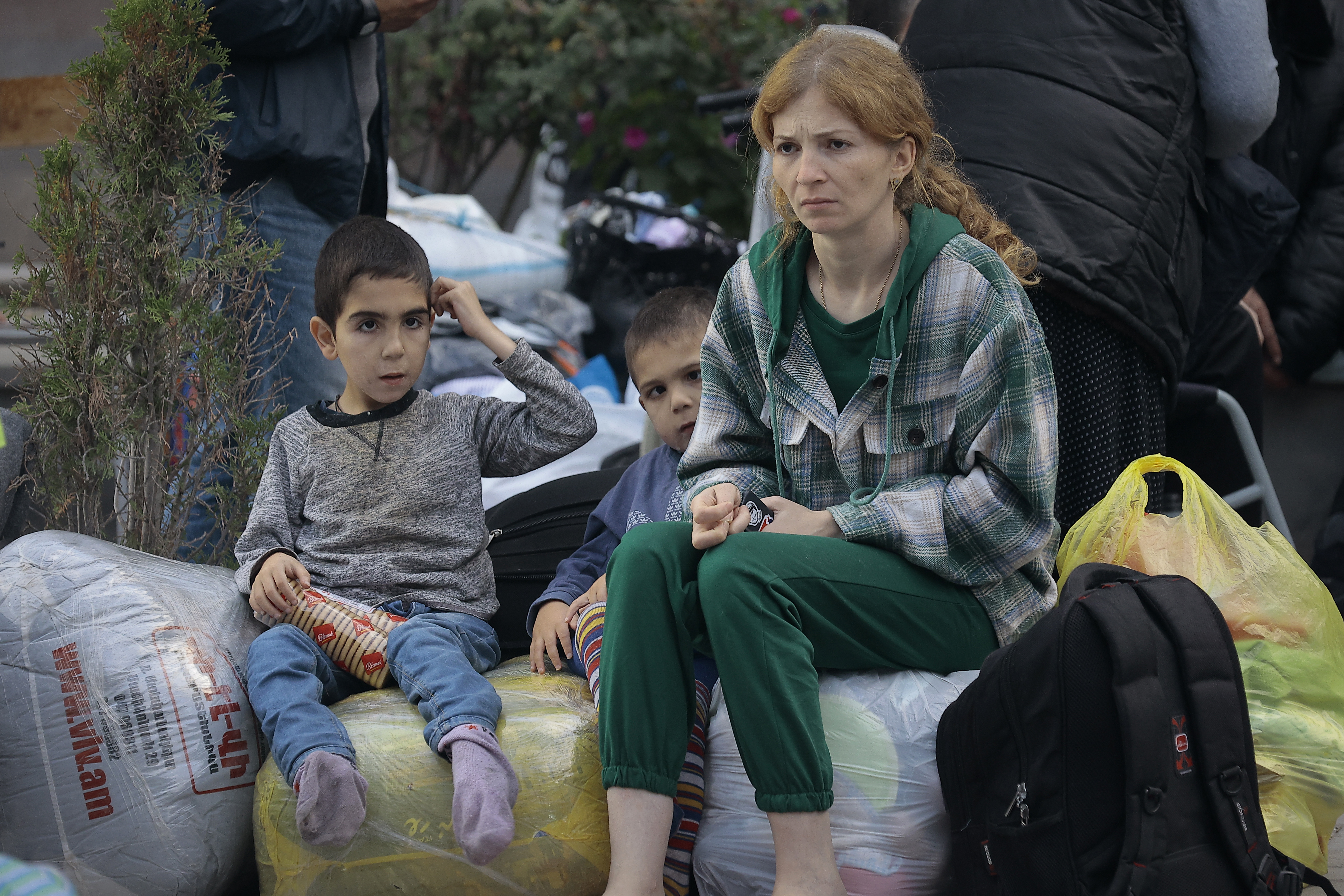 Ethnic Armenians from Nagorno-Karabakh sit after arriving in Armenia's Goris in Syunik region, Armenia