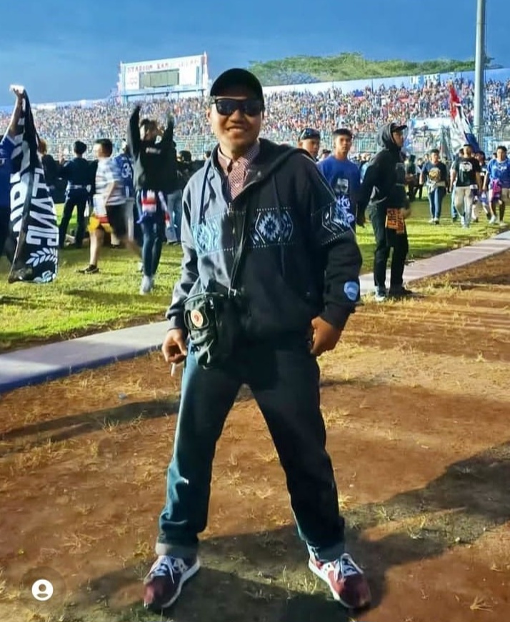 Agus Rian Syah Pratama Putra stands with his legs apart at a football match in Malang