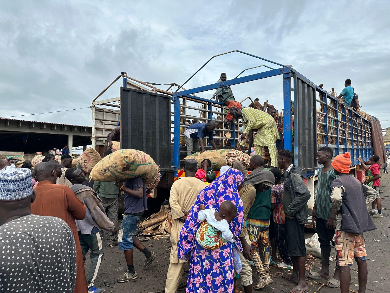 Sacks of onions being offloaded from a vehicle from Niger at the Adjen Kotoku Market in Ghana