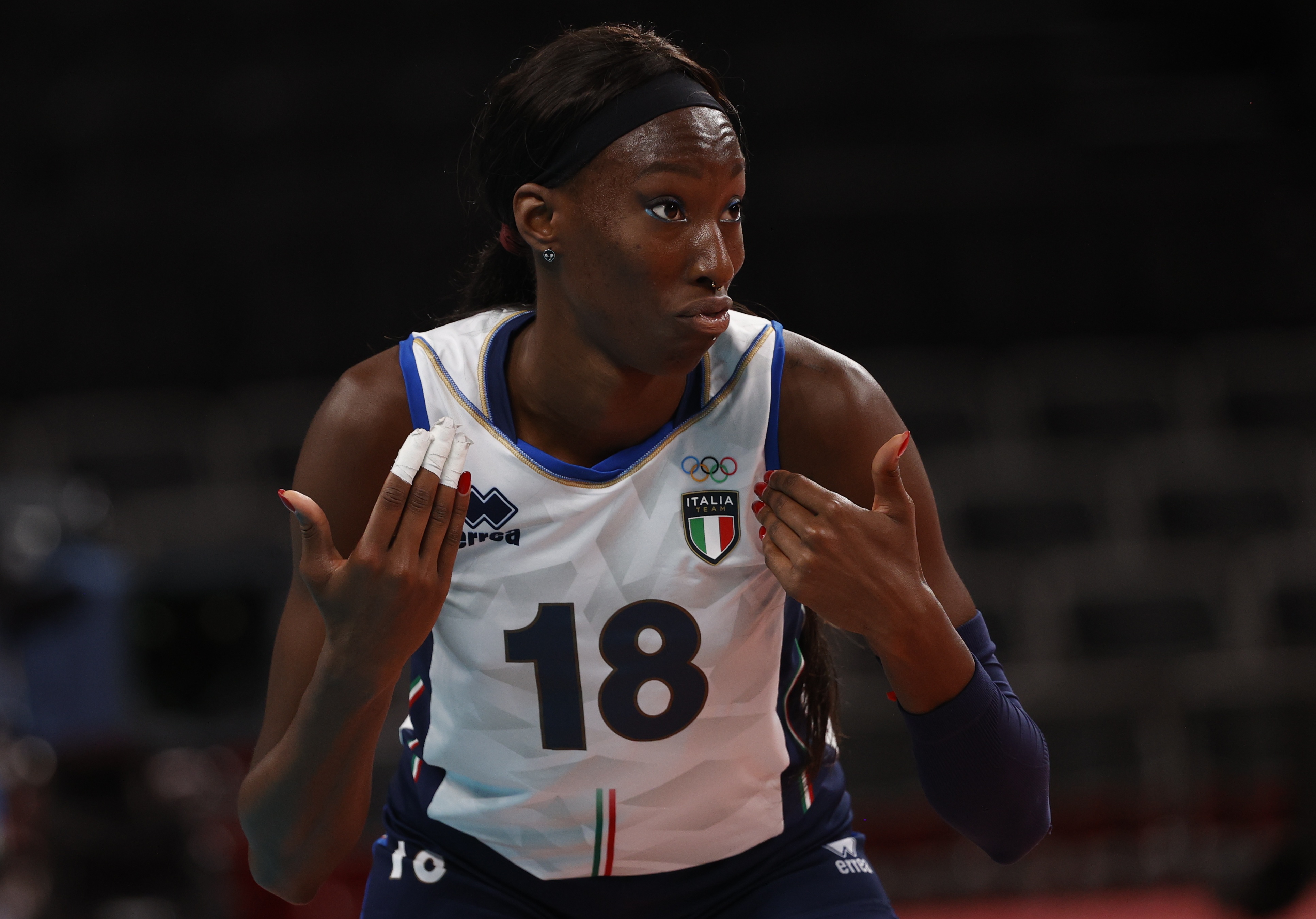 Paola Egonu of Italy gestures towards herself while wearing an Italy volleyball shirt