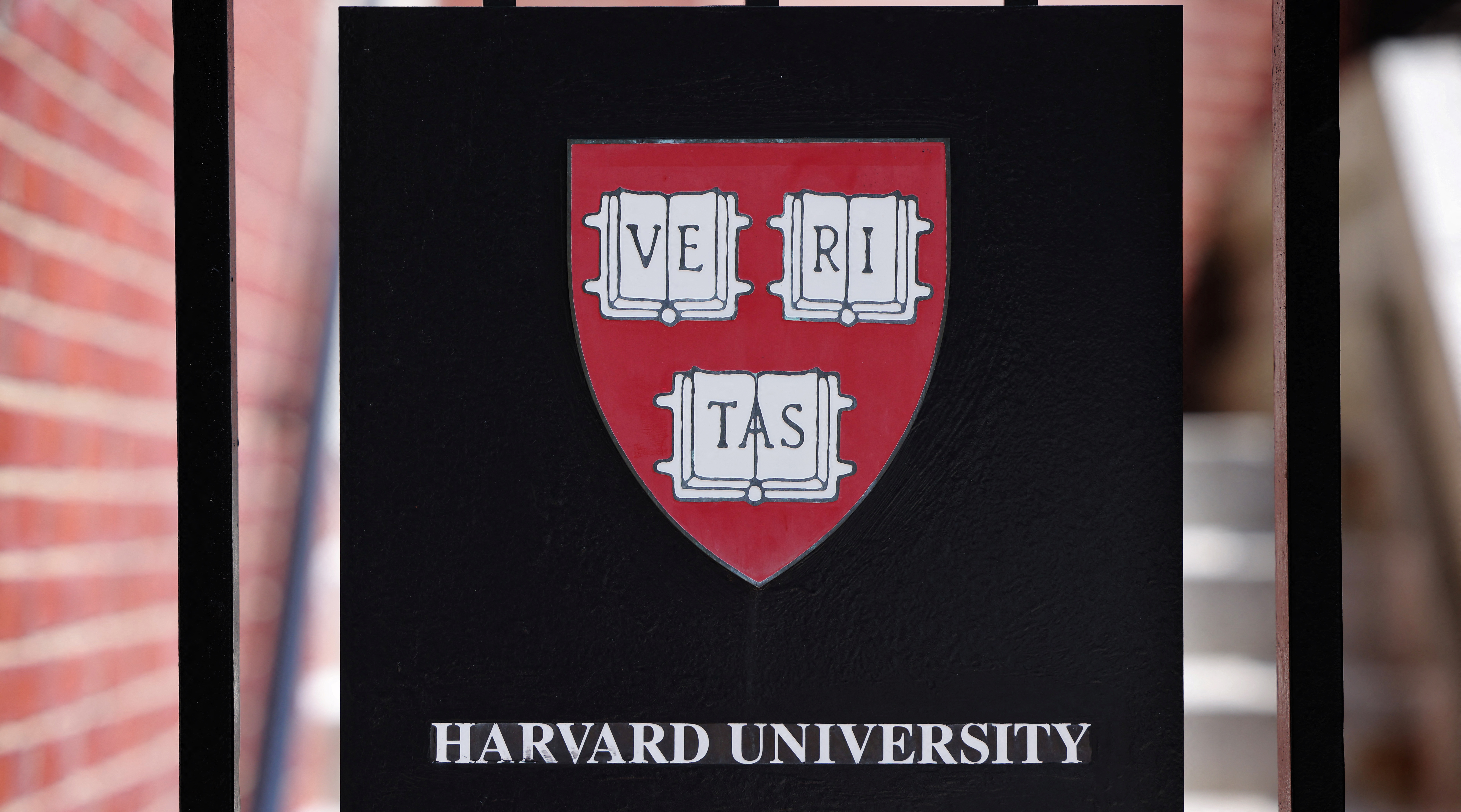 A sign hangs on a gate of a building at Harvard University in Cambridge, Massachusetts