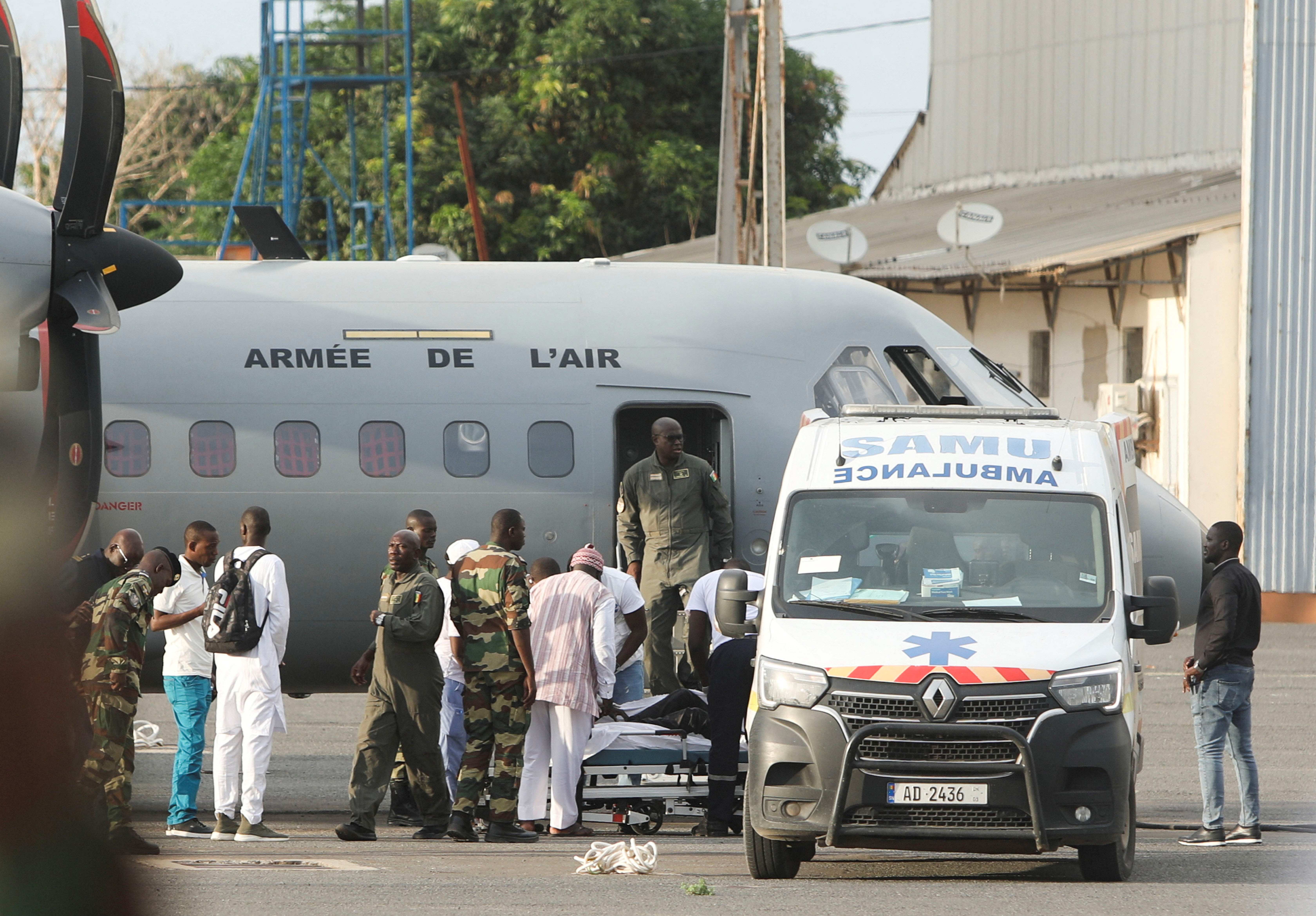 Surviving migrants, from the boat lost at sea during July and found in Cape Verde with several survivors, arrive on the runway at the Dakar-Ouakam Air Base, in Dakar, Senegal August 21, 2023. REUTERS/Ngouda Dione