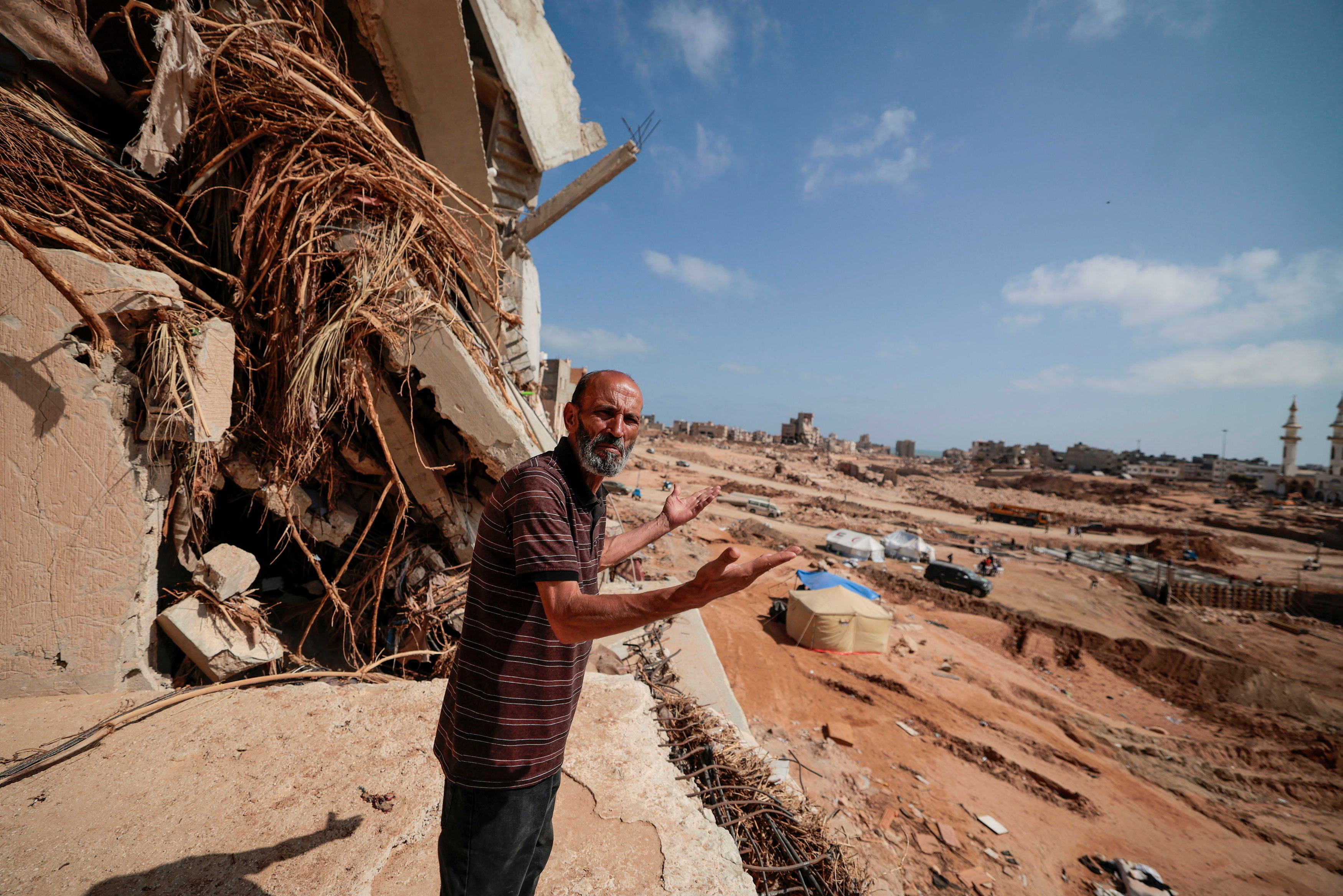 Hamdi Cheikh, who survived the deadly storm that hit Libya, reacts he speaks to journalists in Derna,