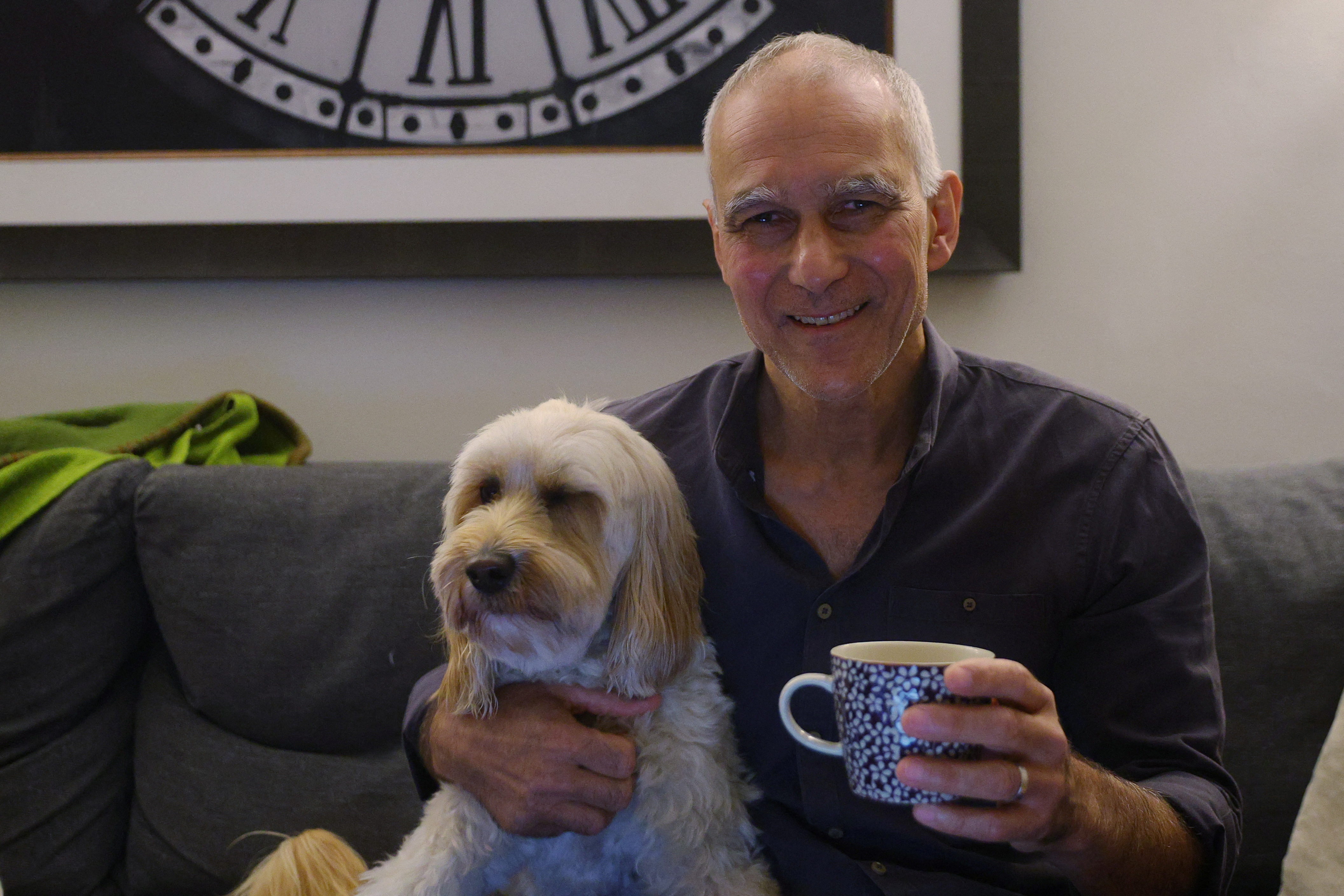 Moungi Bawendi, a professor at the Massachusetts Institute of Technology (MIT), sits with his dog Phoebe at home after winning the 2023 Nobel Prize in Chemistry, in Cambridge, Massachusetts, U.S., October 4, 2023. REUTERS/Brian Snyder