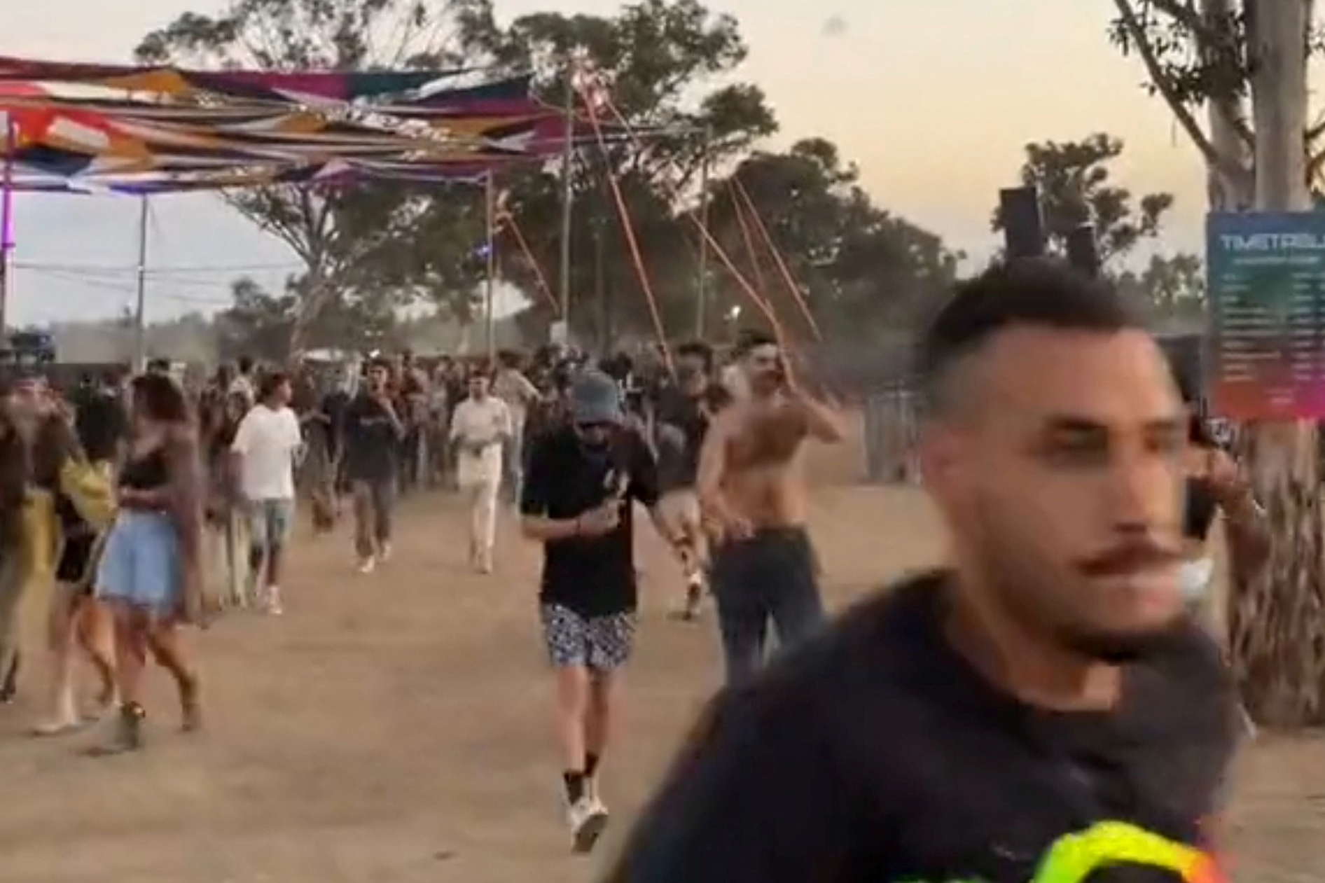 People at a dance party flee during a surprise attack launched by Hamas, near Reim, Israel