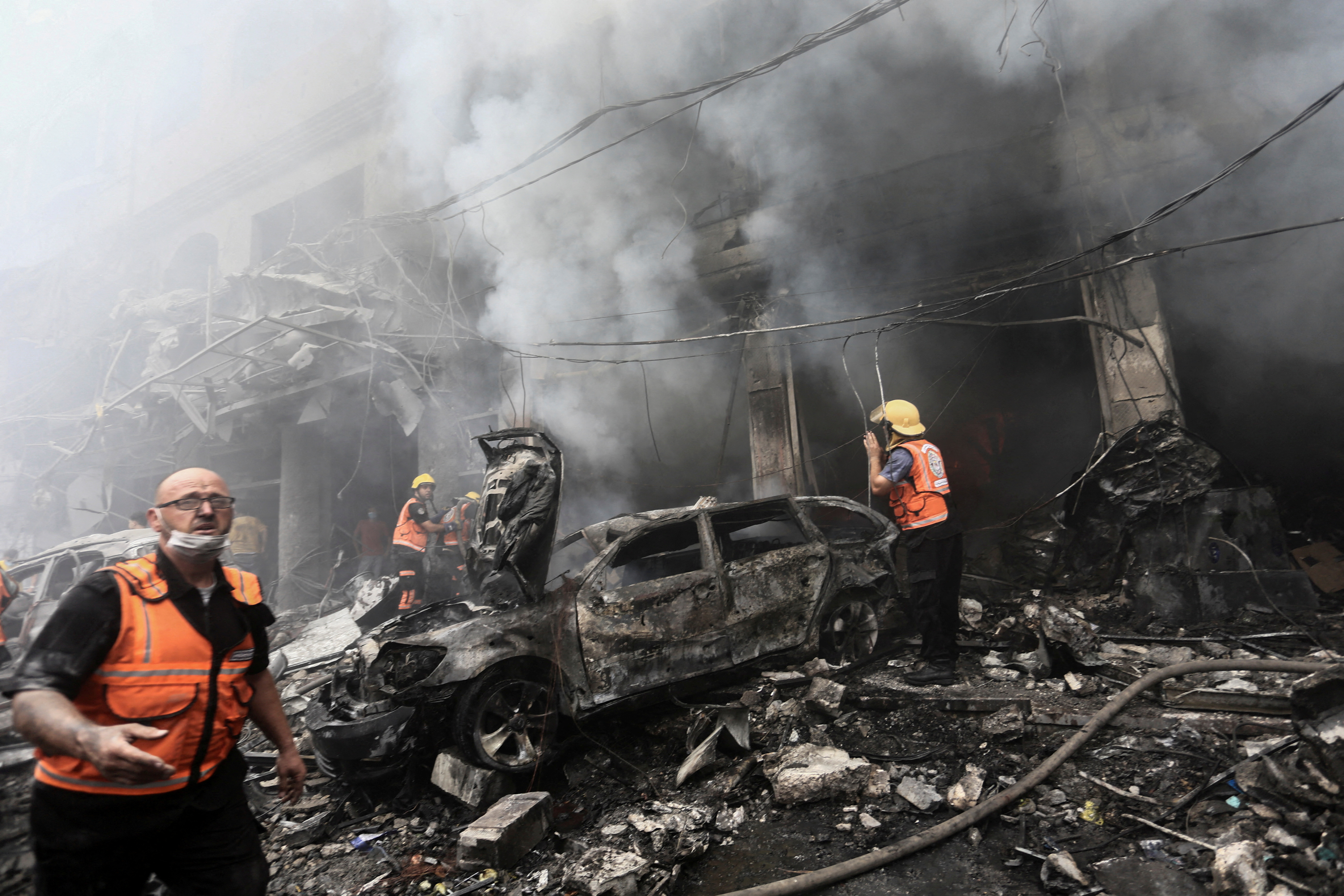Palestinian rescuers work at the site of Israeli strikes, in Jabalia refugee camp, in the northern Gaza Strip