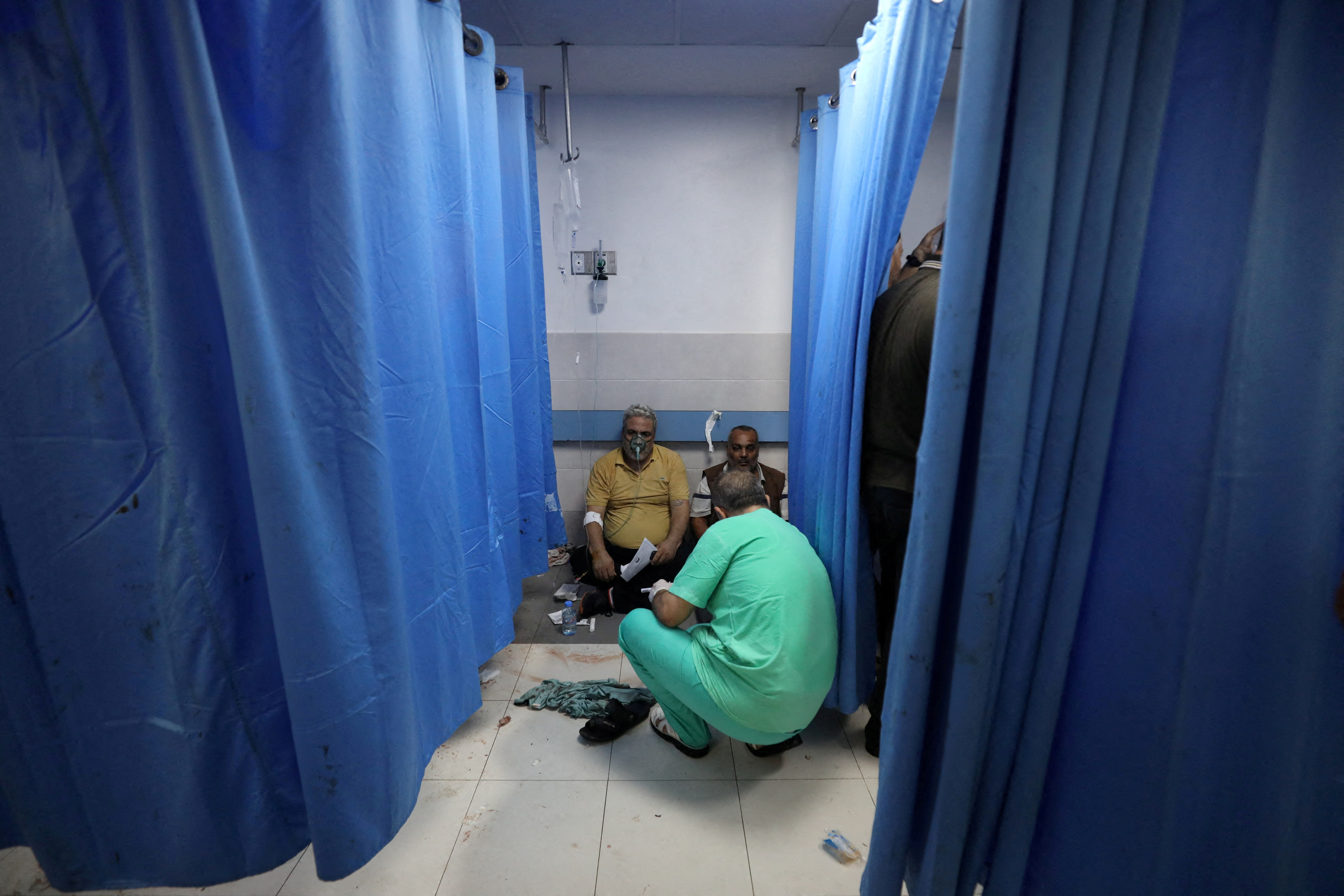 People are assisted at Shifa Hospital after hundreds of Palestinians were killed in a blast at Al-Ahli hospital in Gaza