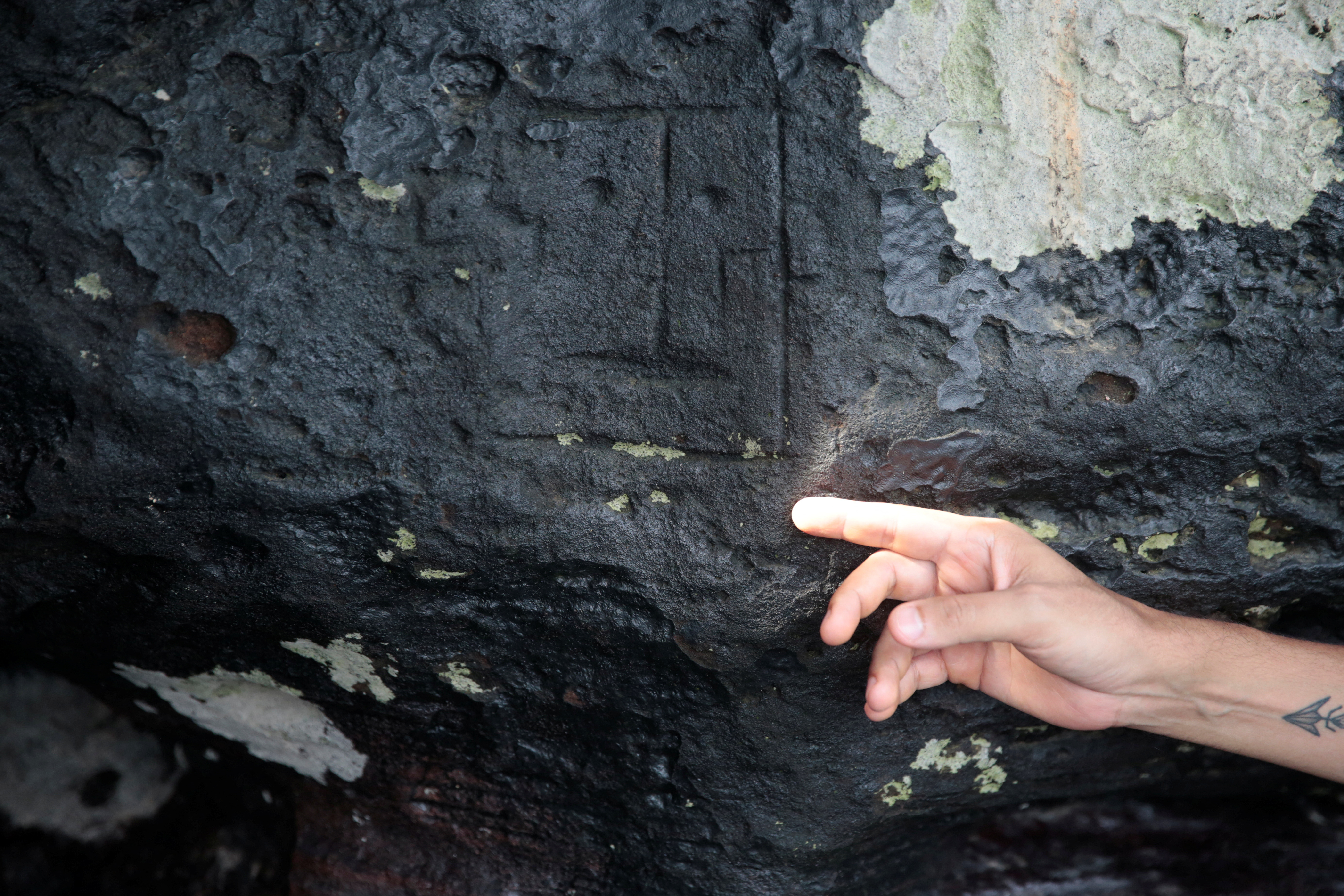 A view of ancient stone carvings on a rocky point of the Amazon river