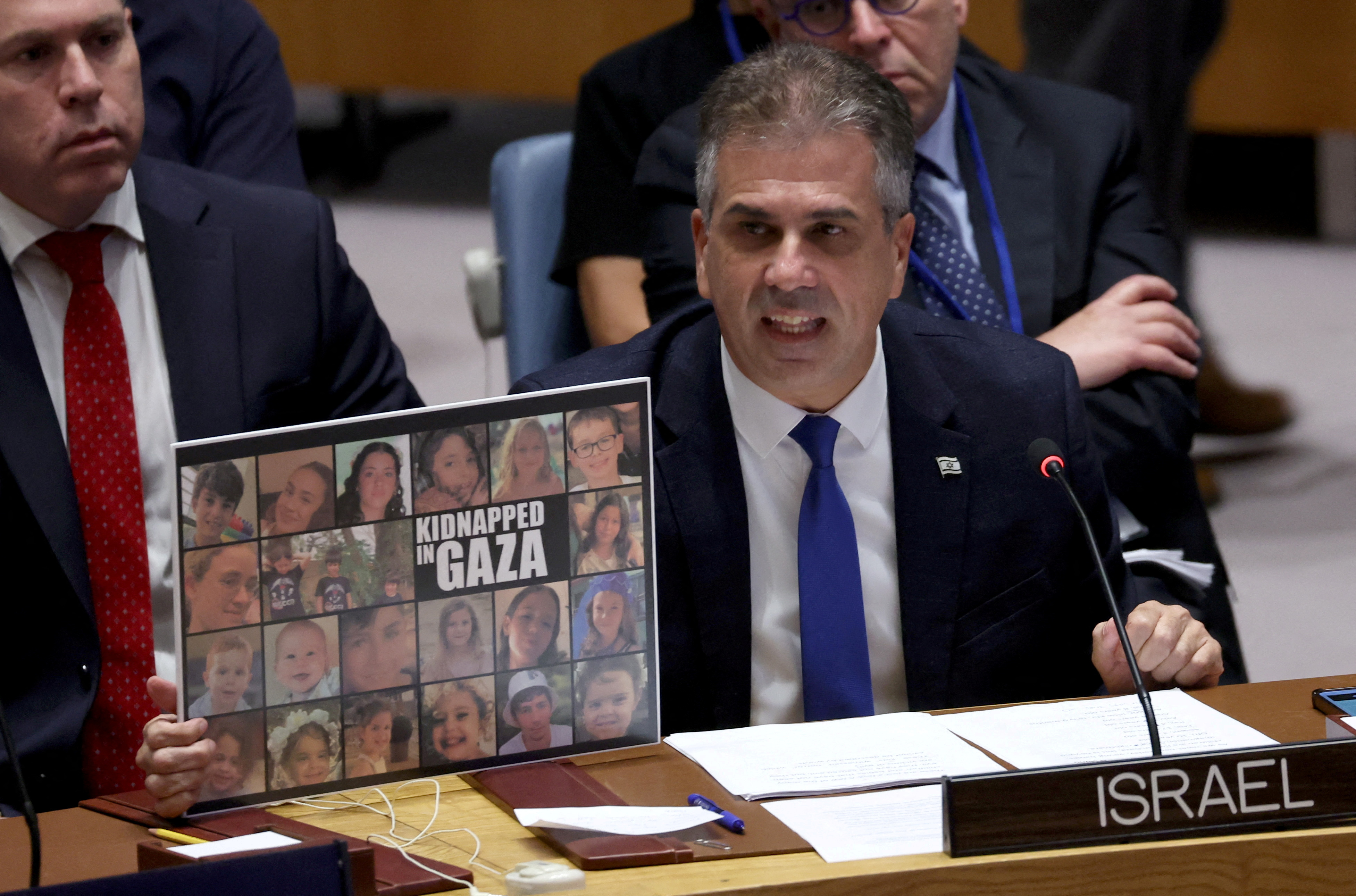 Israeli Foreign Minister Eli Cohen at the Security Council. He has placed a composite photo of the estimated 200 people held capitve in Gaza by Hamas.