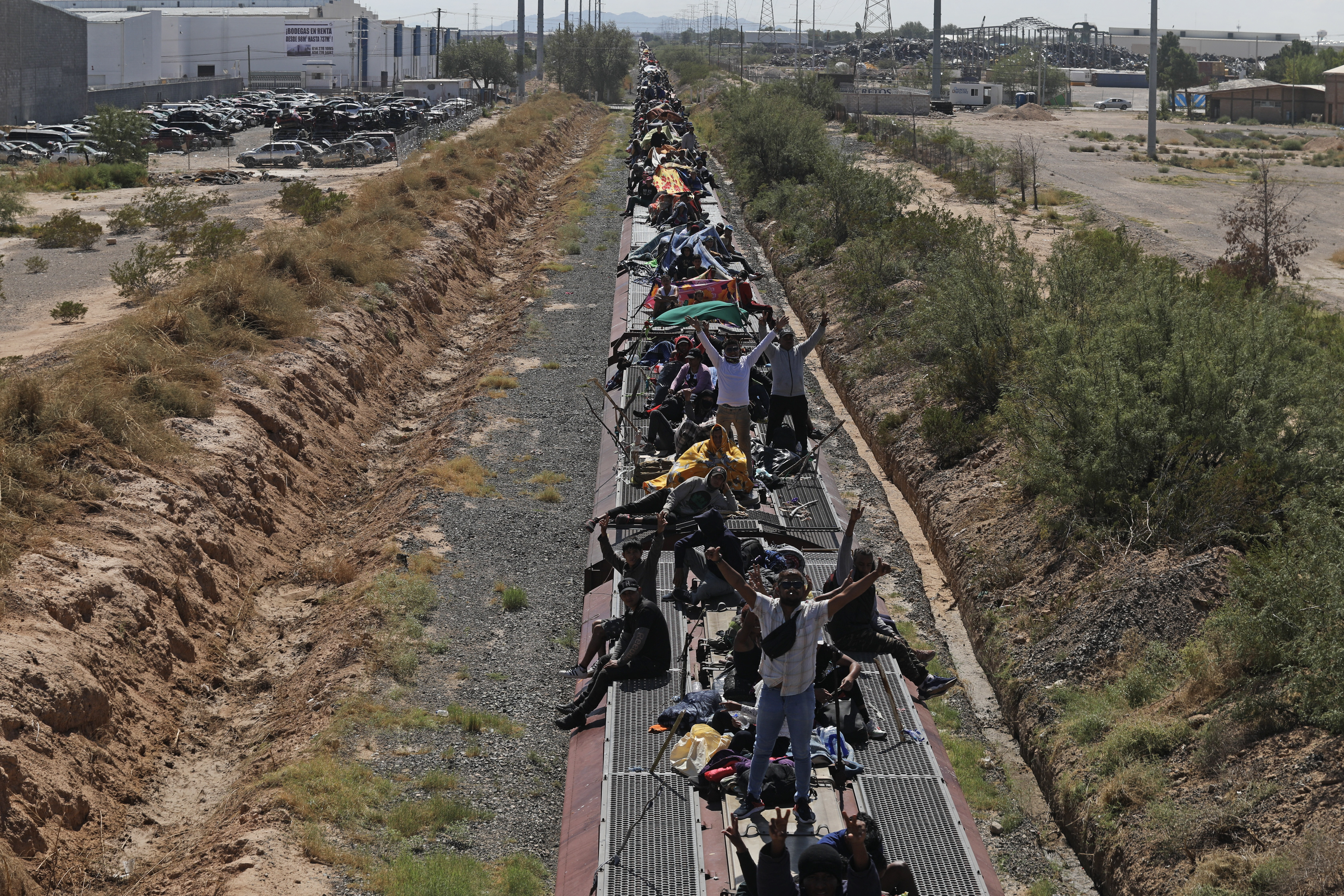 Migrant people, mostly from Venezuela, travel on the wagons of a goods train to Ciudad Juarez,