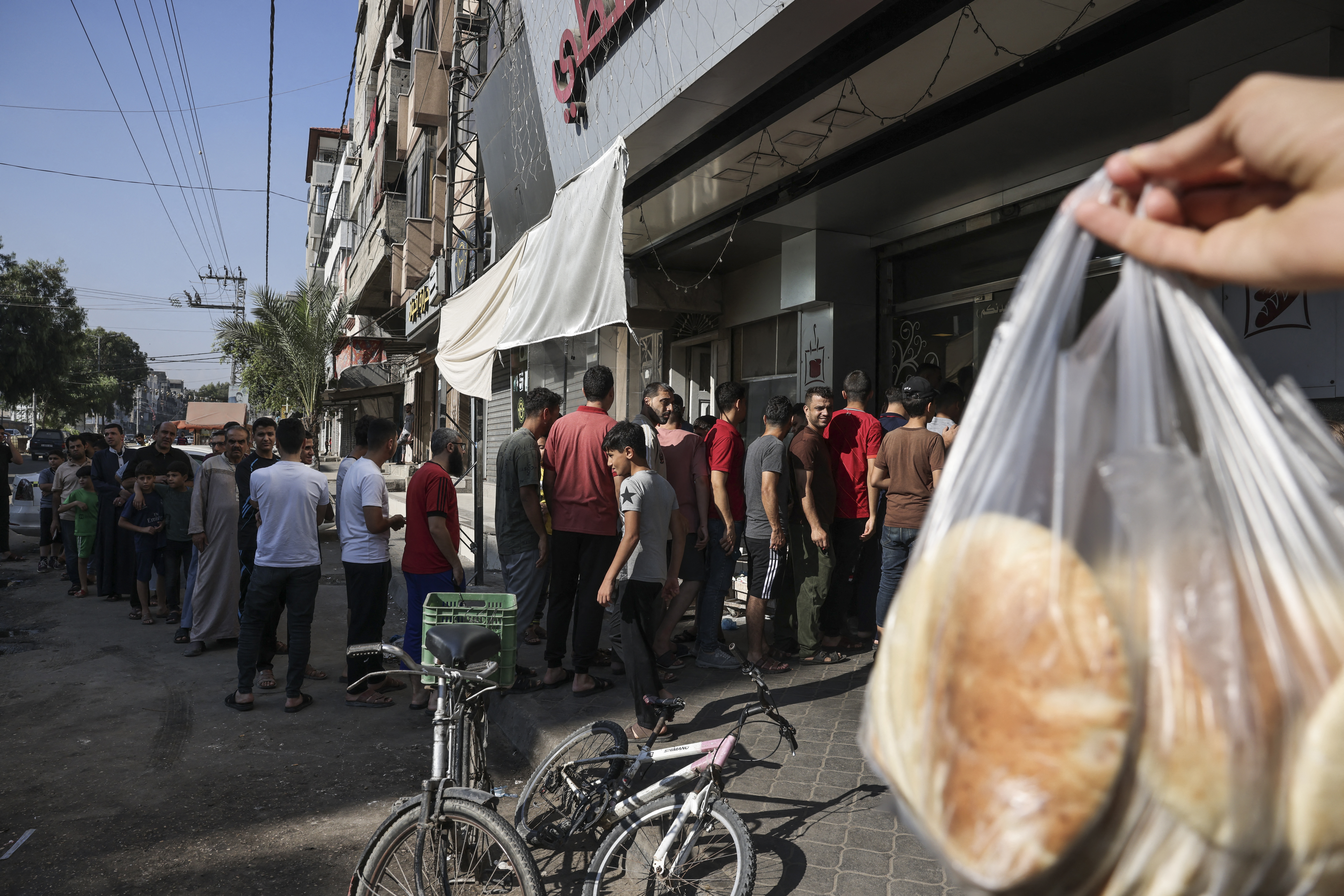 People queue outside a bakery in Gaza City