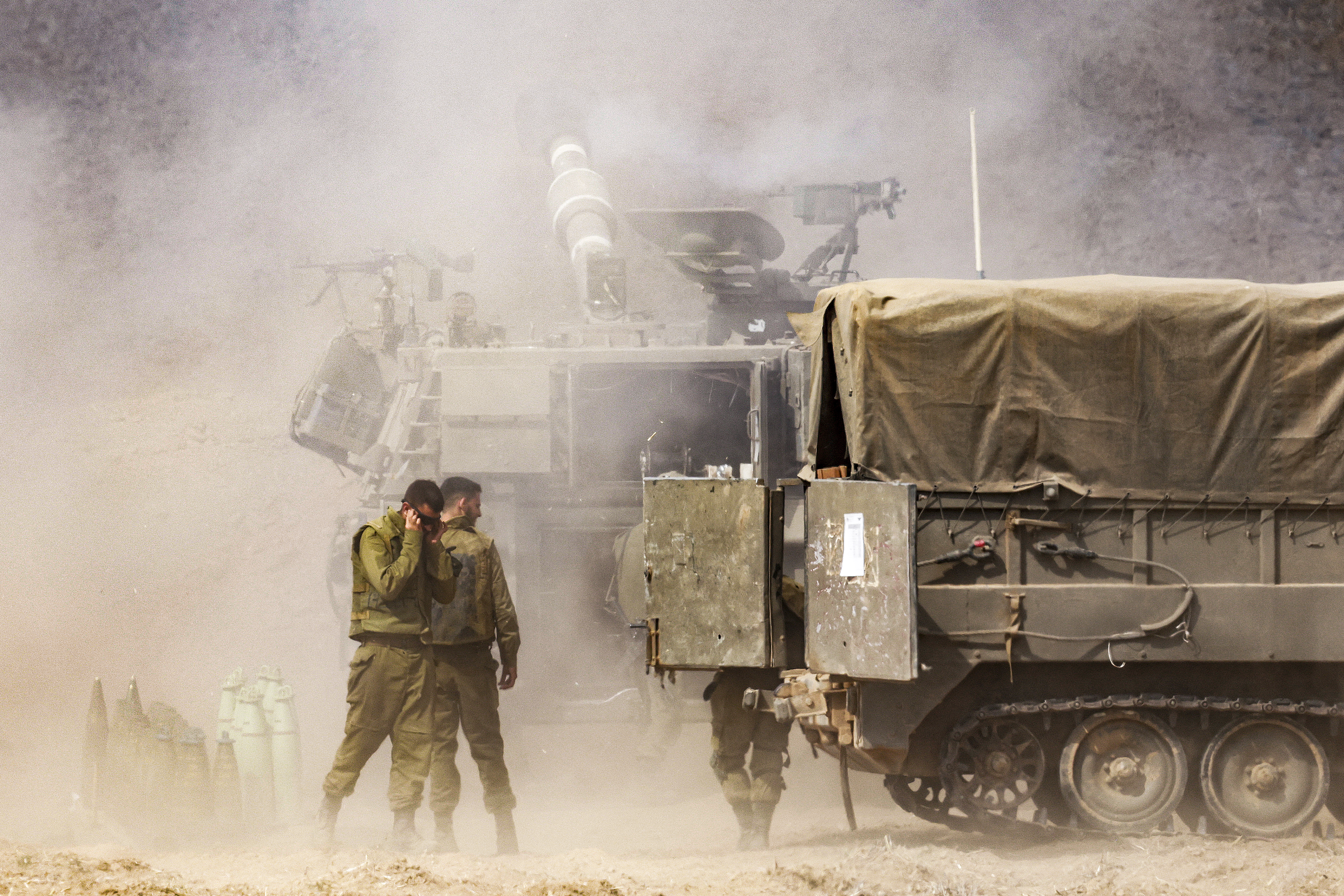 An Israeli army self-propelled howitzer fires rounds near the border with Gaza