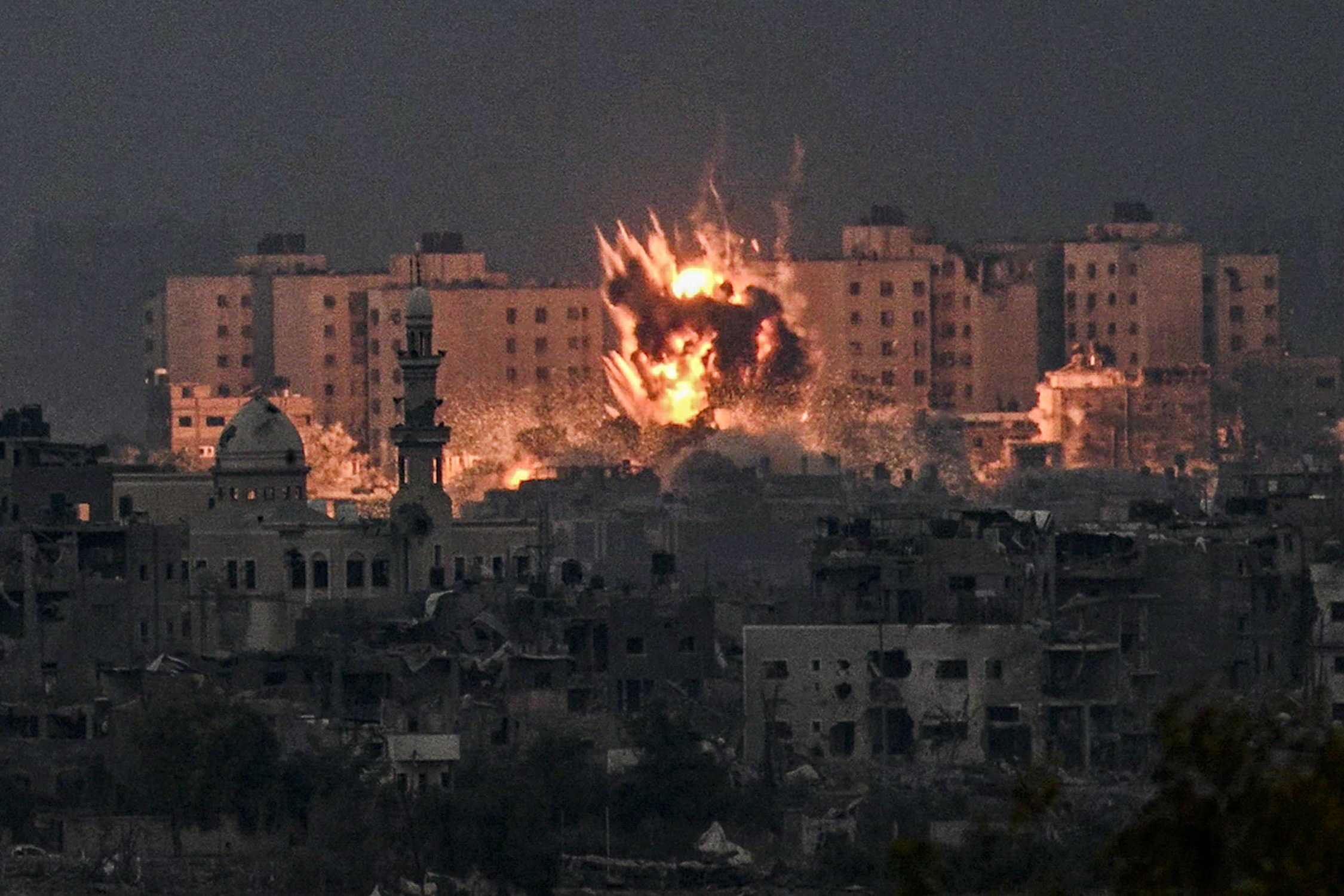 A fireball erupts during Israeli bombardment in the northern Gaza Strip on October 14, 2023.