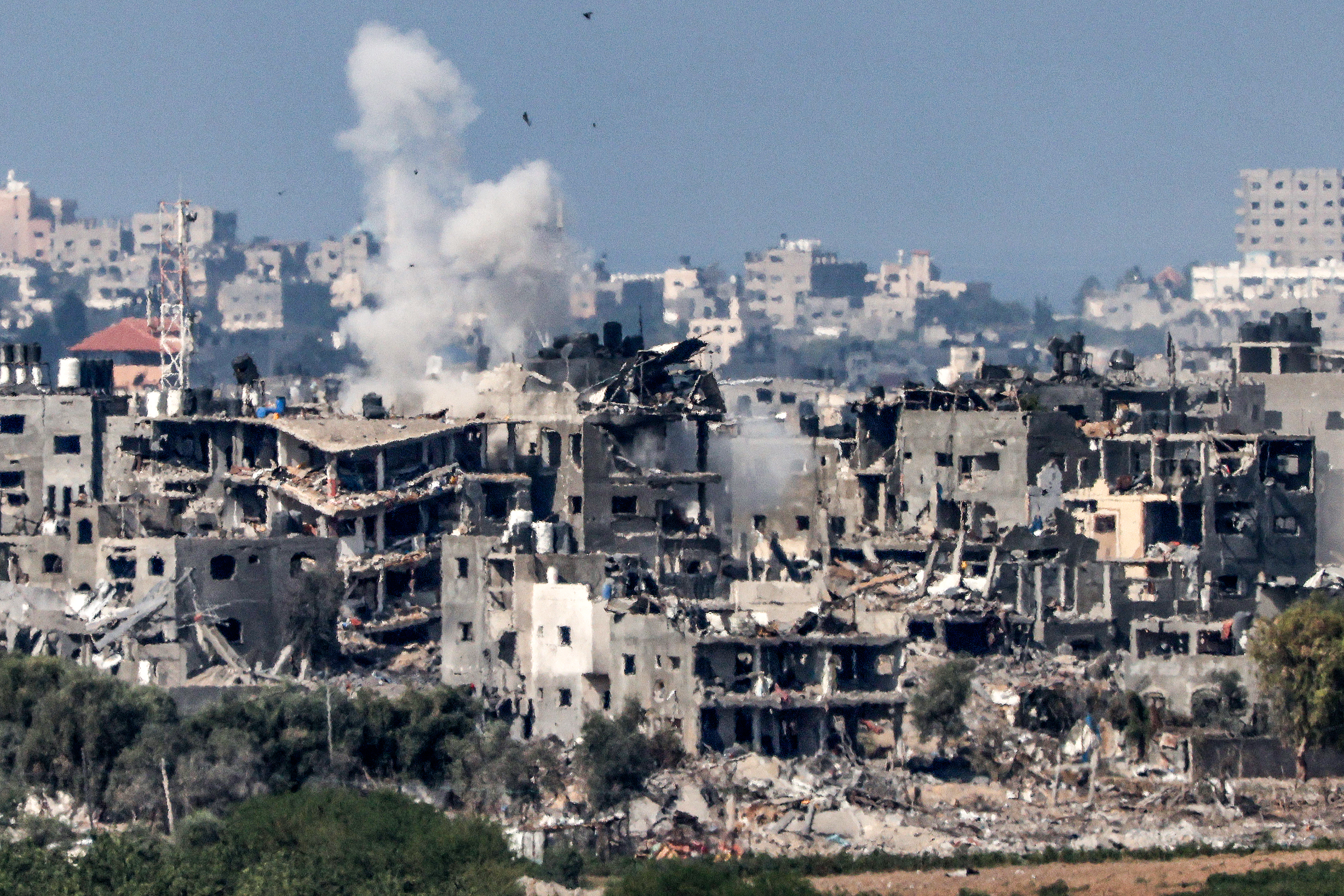 This picture taken from Israel's southern city of Sderot shows a smoke plume erupting during Israeli bombardment in the northern Gaza Strip on October 19, 2023 [Jack Guez/AFP]