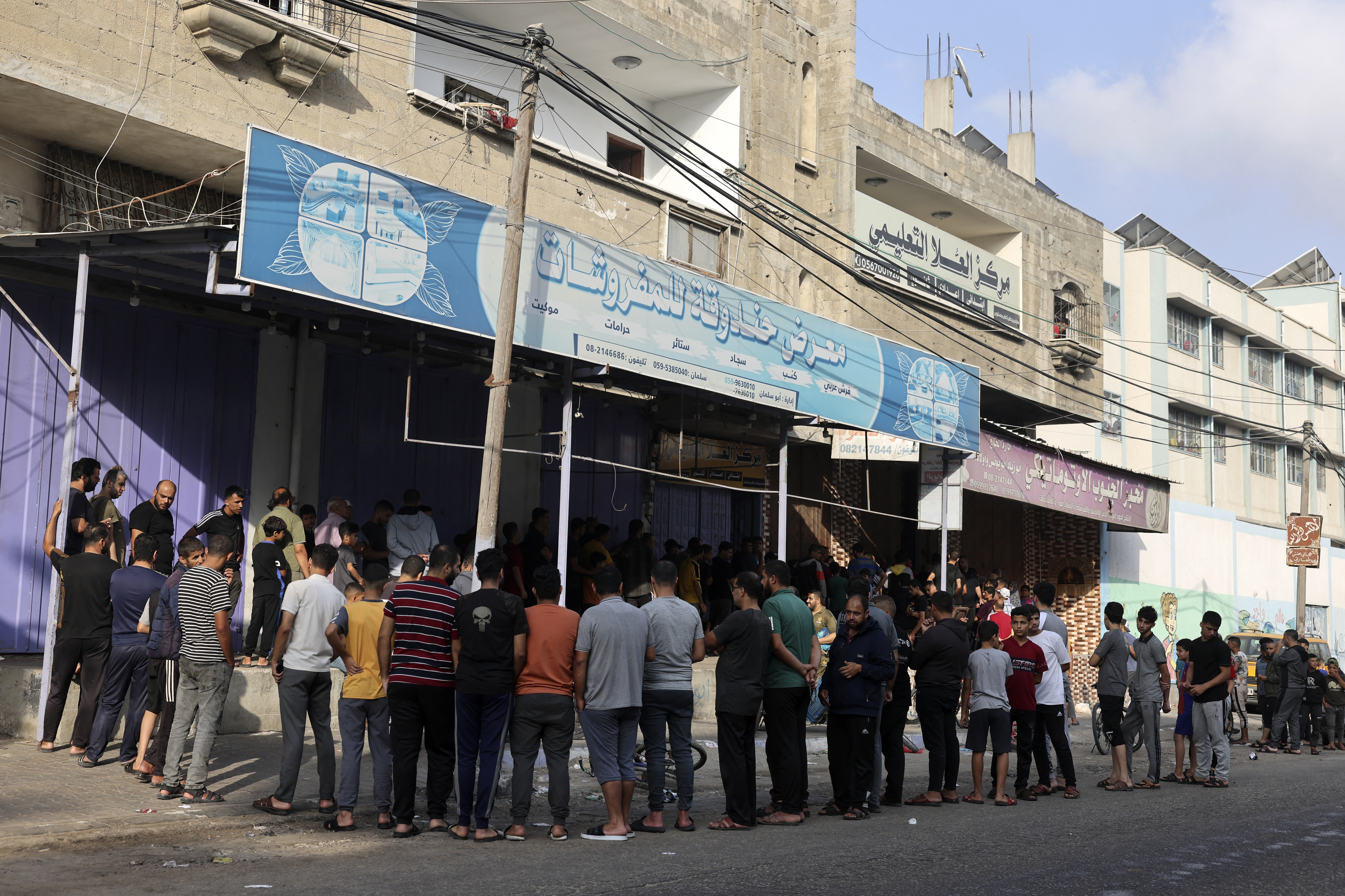 People queue in front of a bakery in Rafah