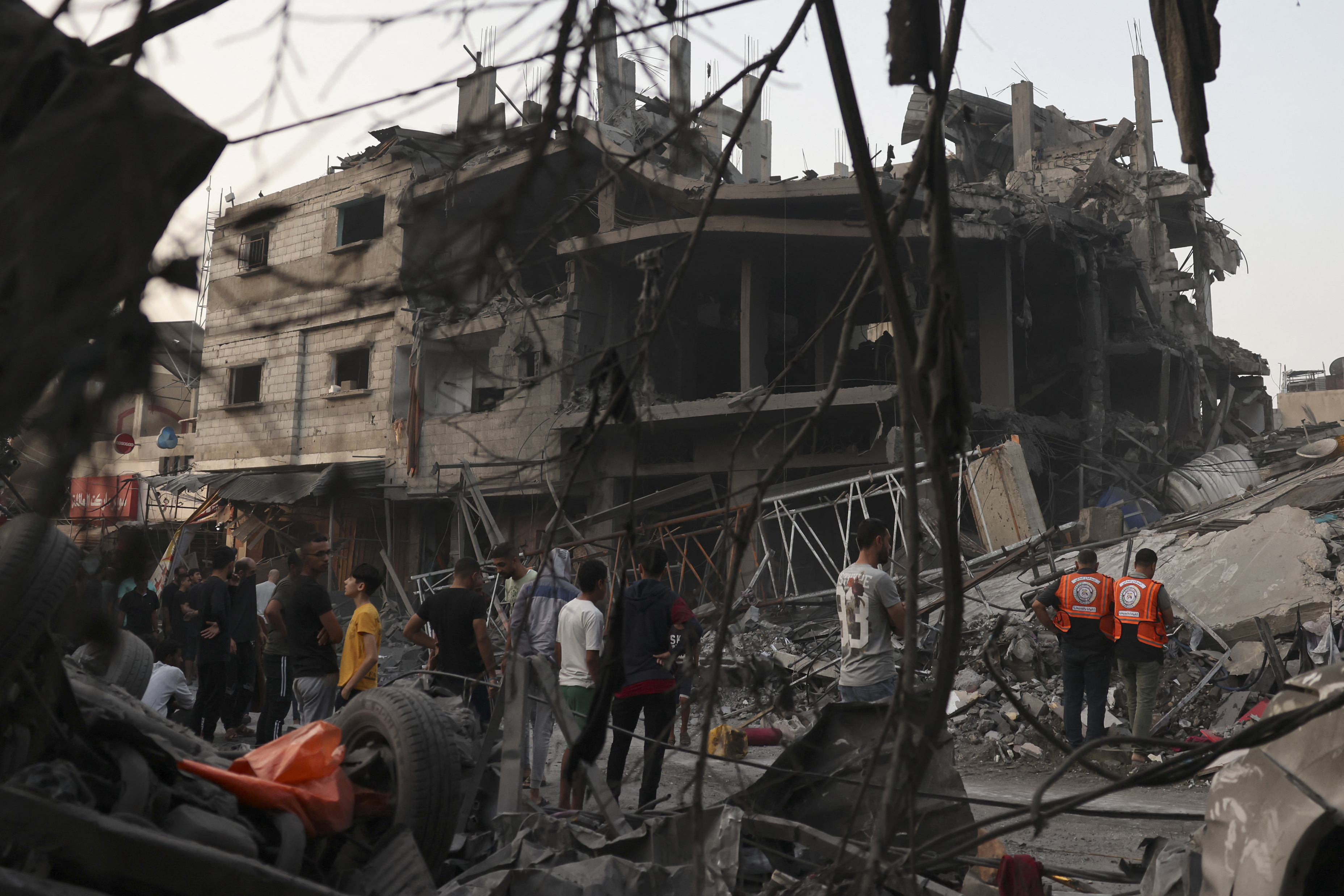 Palestinians inspect the rubble of a building following overnight Israeli strikes on the Rafah refugee camp