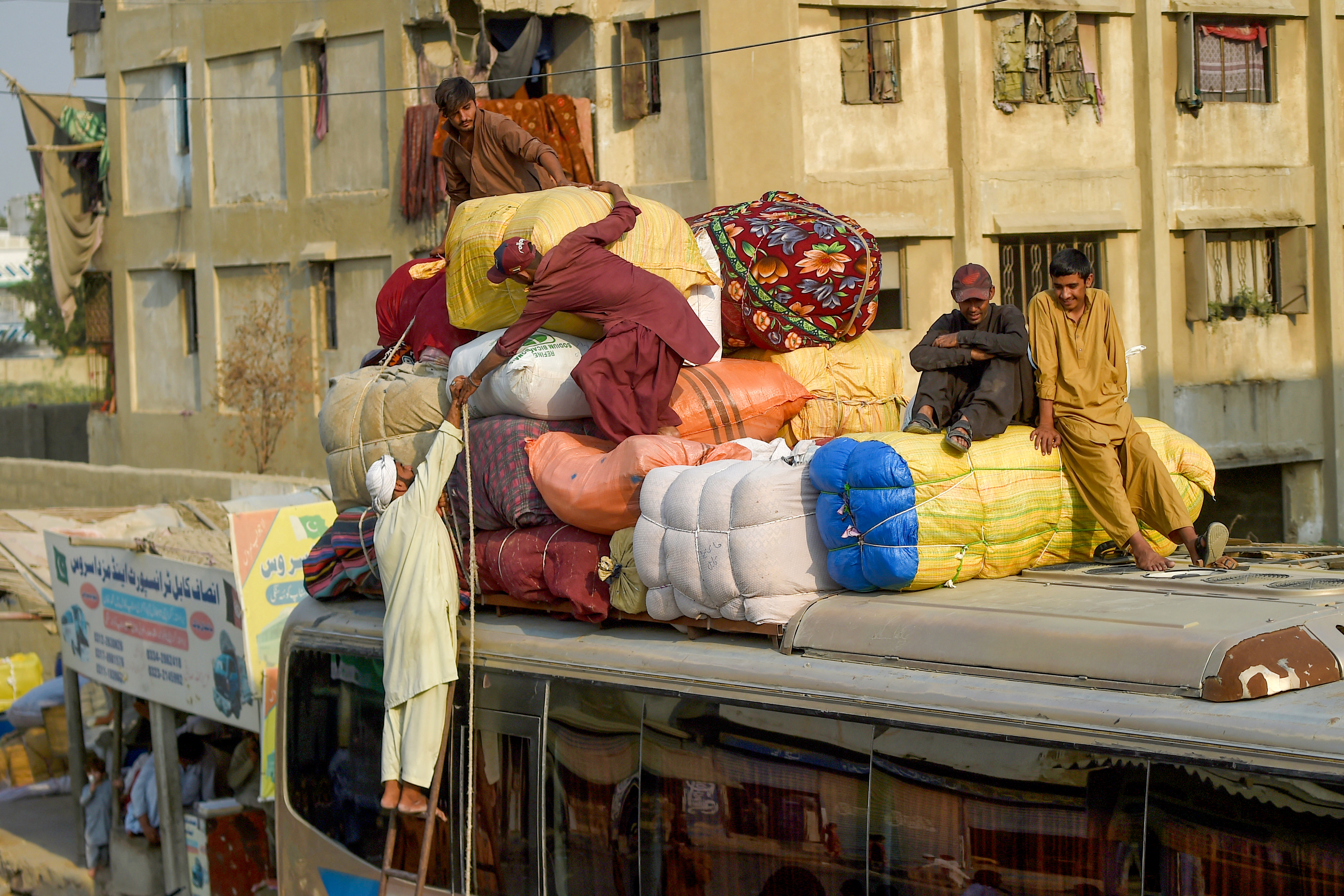 Afghan refugees depart for Afghanistan from the Karachi bus terminal