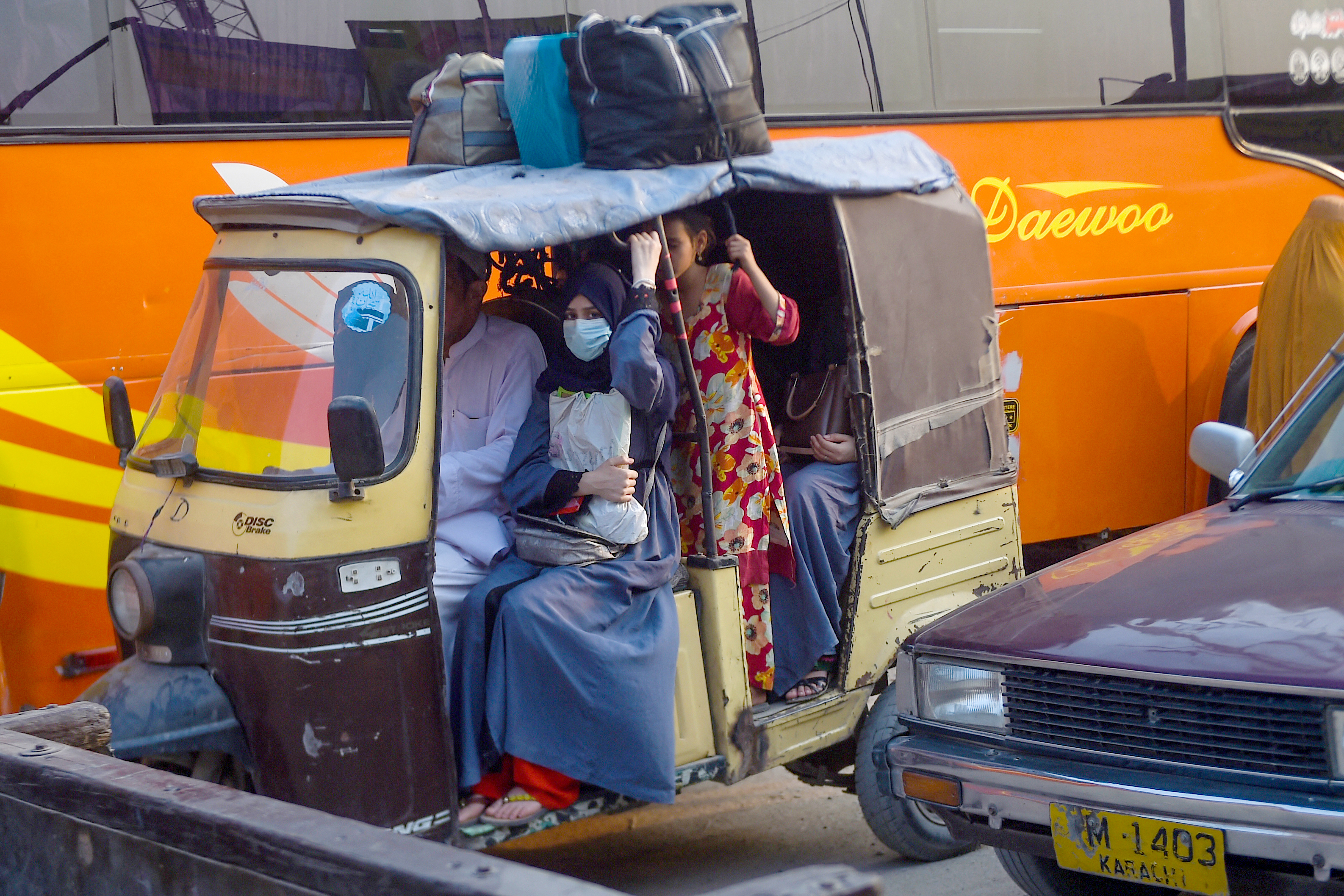 Afghan refugees arrive at the Karachi bus terminal in Sindh province, to depart for Afghanistan