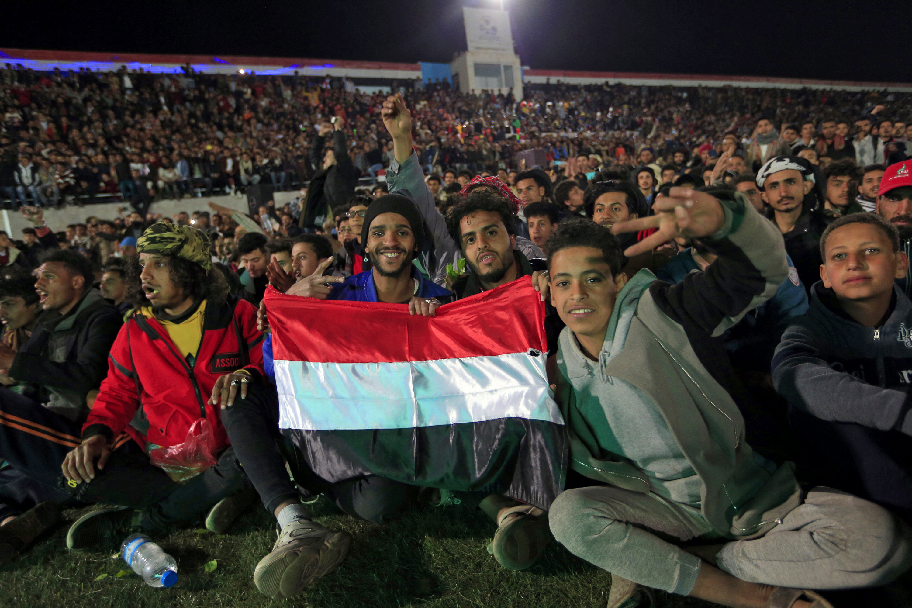 Yemeni fans gather at a stadium to watch on a screen the West Asian Junior Championships Cup football match between Yemen and Saudi Arabia,