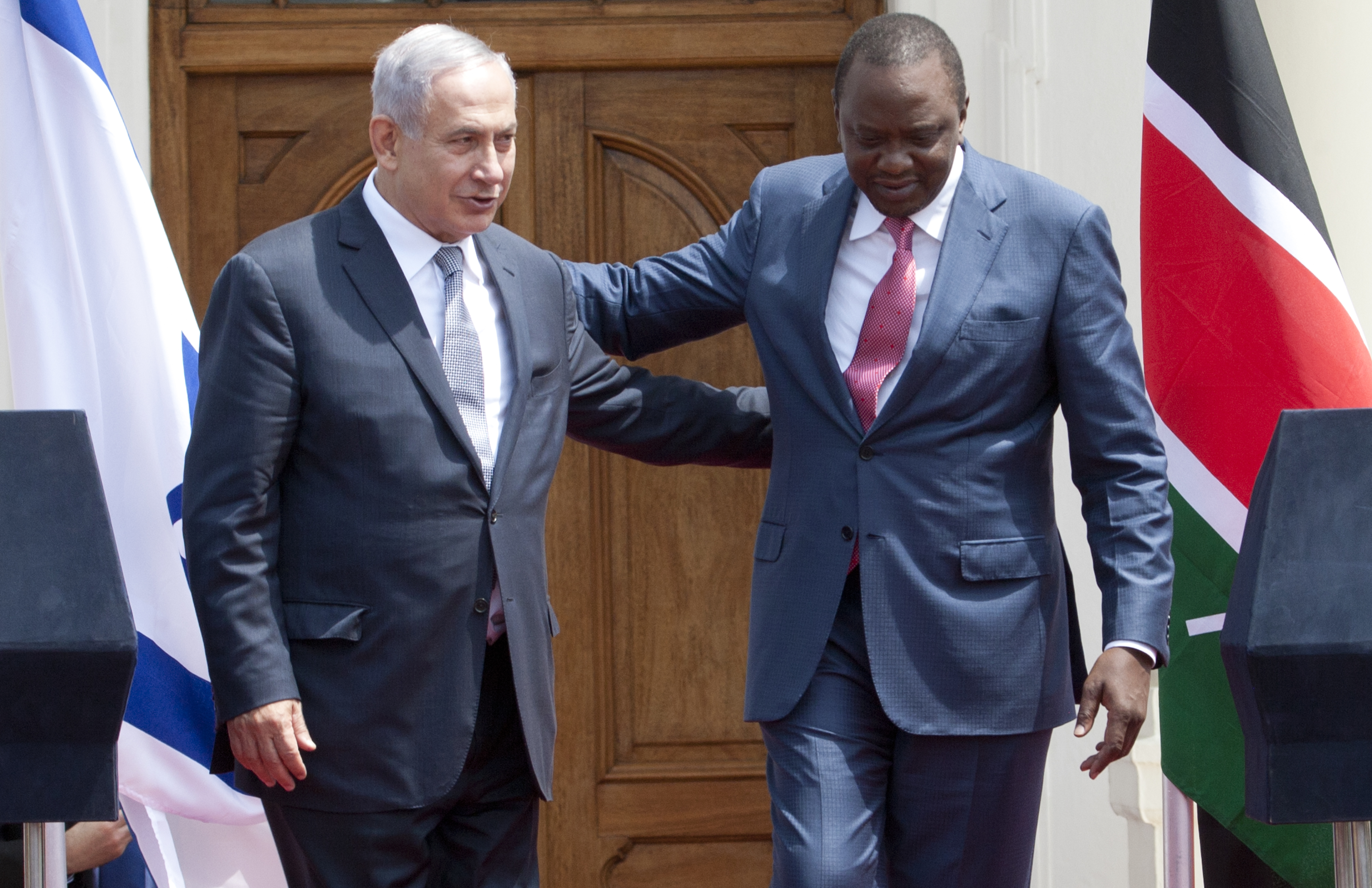 Israeli Prime Minister Benjamin Netanyahu, left, and Kenyan President, Uhuru Kenyatta, right, walk together after giving a joint press conference at State House in Nairobi, Kenya, Tuesday, July 5, 2016. Netanyahu is in Kenya as part of his four-nation tour of Africa. (AP Photo/Sayyid Abdul Azim)