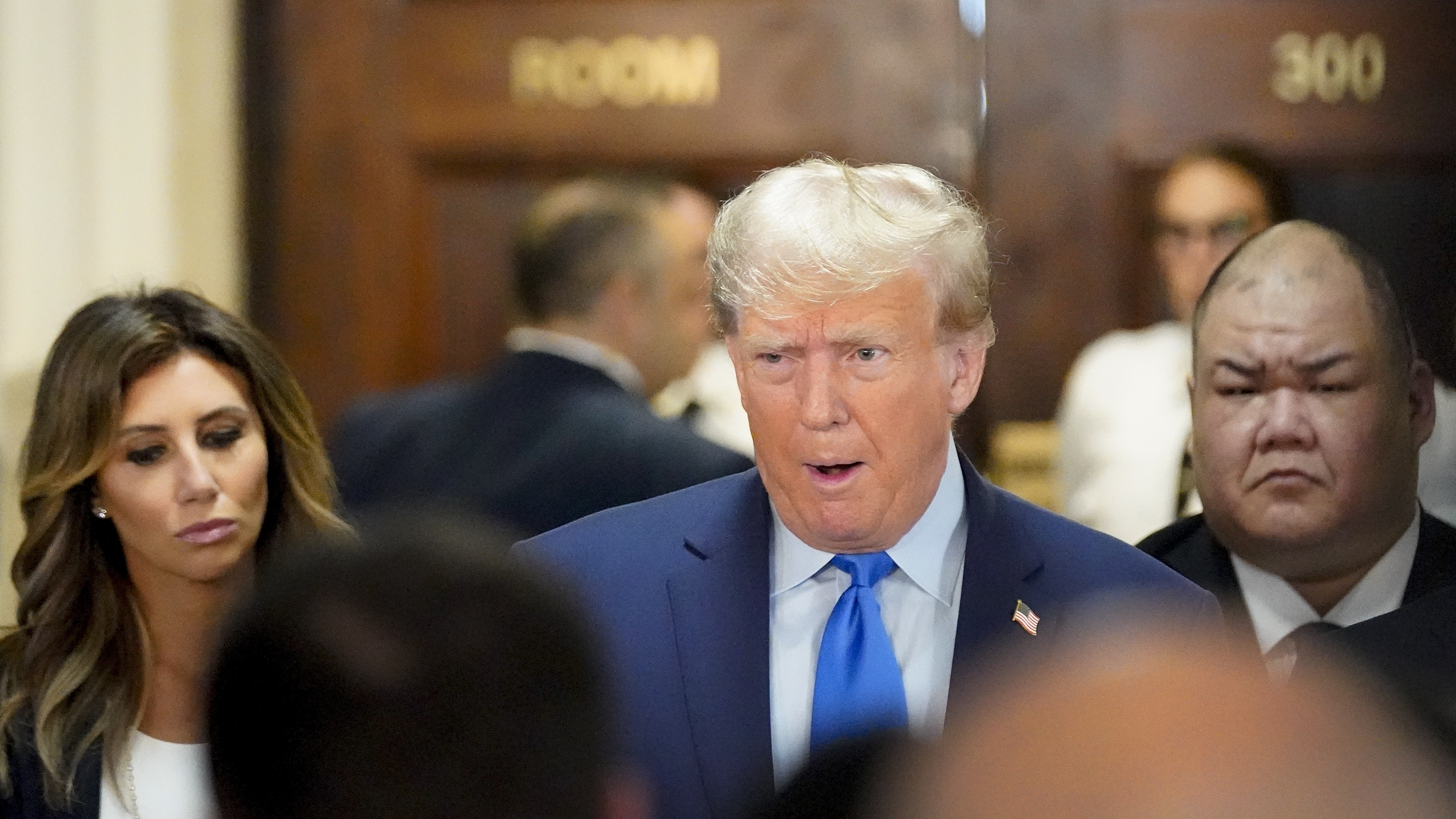 Former President Donald Trump, center, arrives at New York Supreme Court