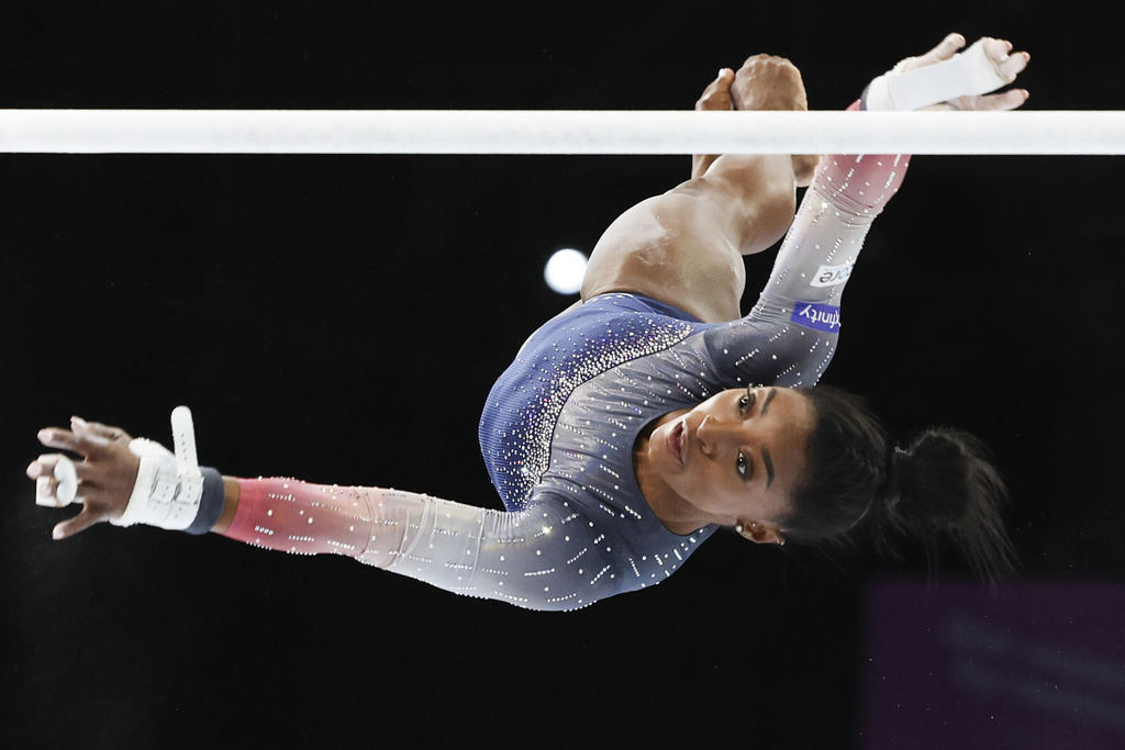 United States' Simone Biles competes on the uneven bars during the women's team final at the Artistic Gymnastics World Championships in Antwerp, Belgium, Wednesday, Oct. 4, 2023. (AP Photo/Geert vanden Wijngaert)