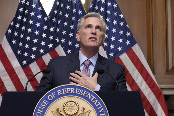 Kevin McCarthy with American flags behind him