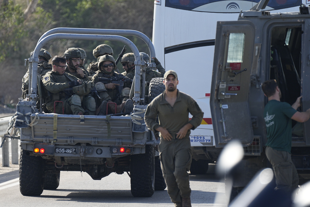 Israeli soldiers head south near Ashkelon, Israel, Israel, on Saturday, Oct. 7, 2023. Palestinian militants in the Gaza Strip infiltrated Saturday into southern Israel and fired thousands of rockets into the country while Israel began striking targets in Gaza in response. (AP Photo/Ohad Zwigenberg)