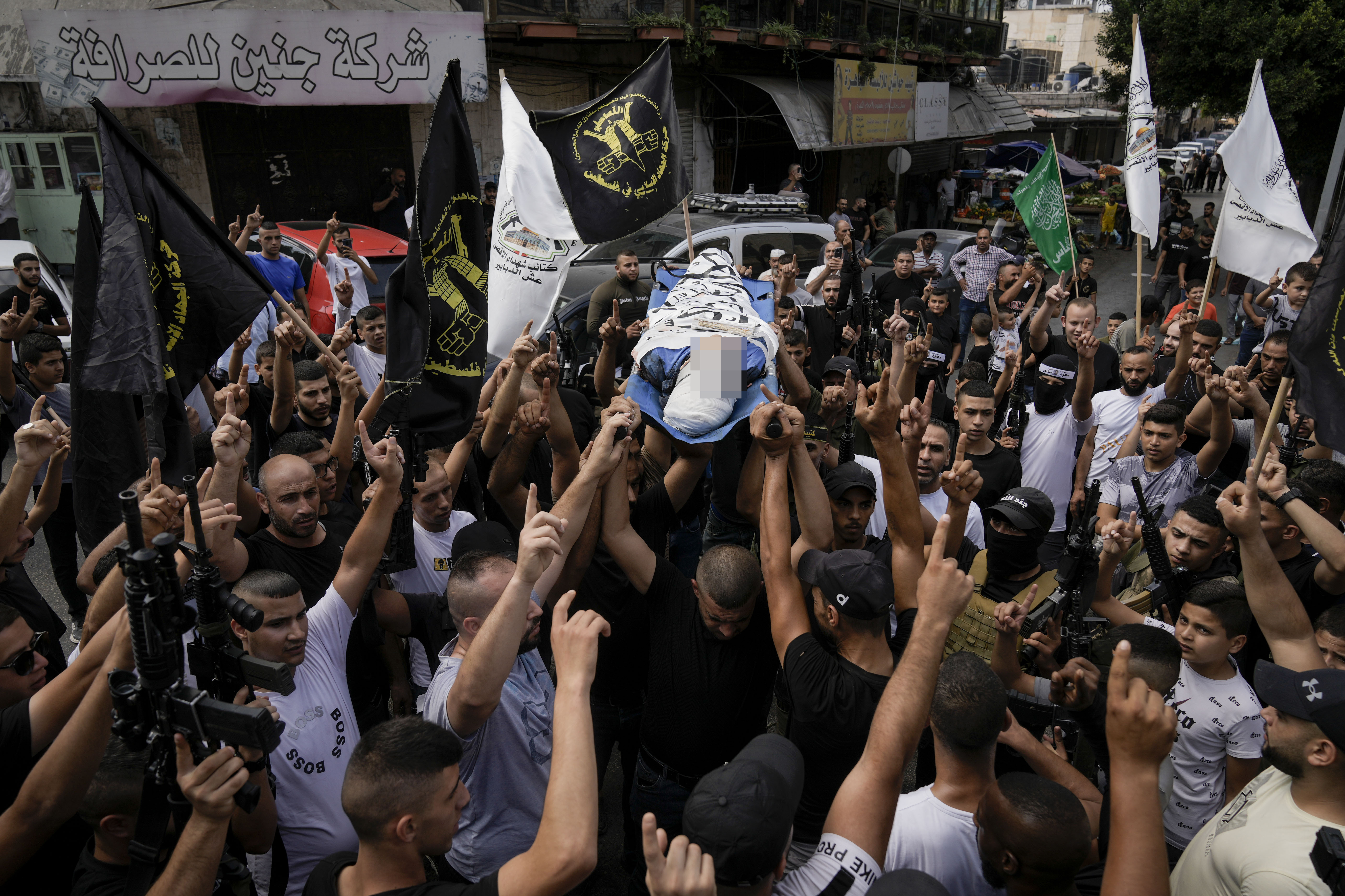 Palestinians carry the body of Ahmad Awawda