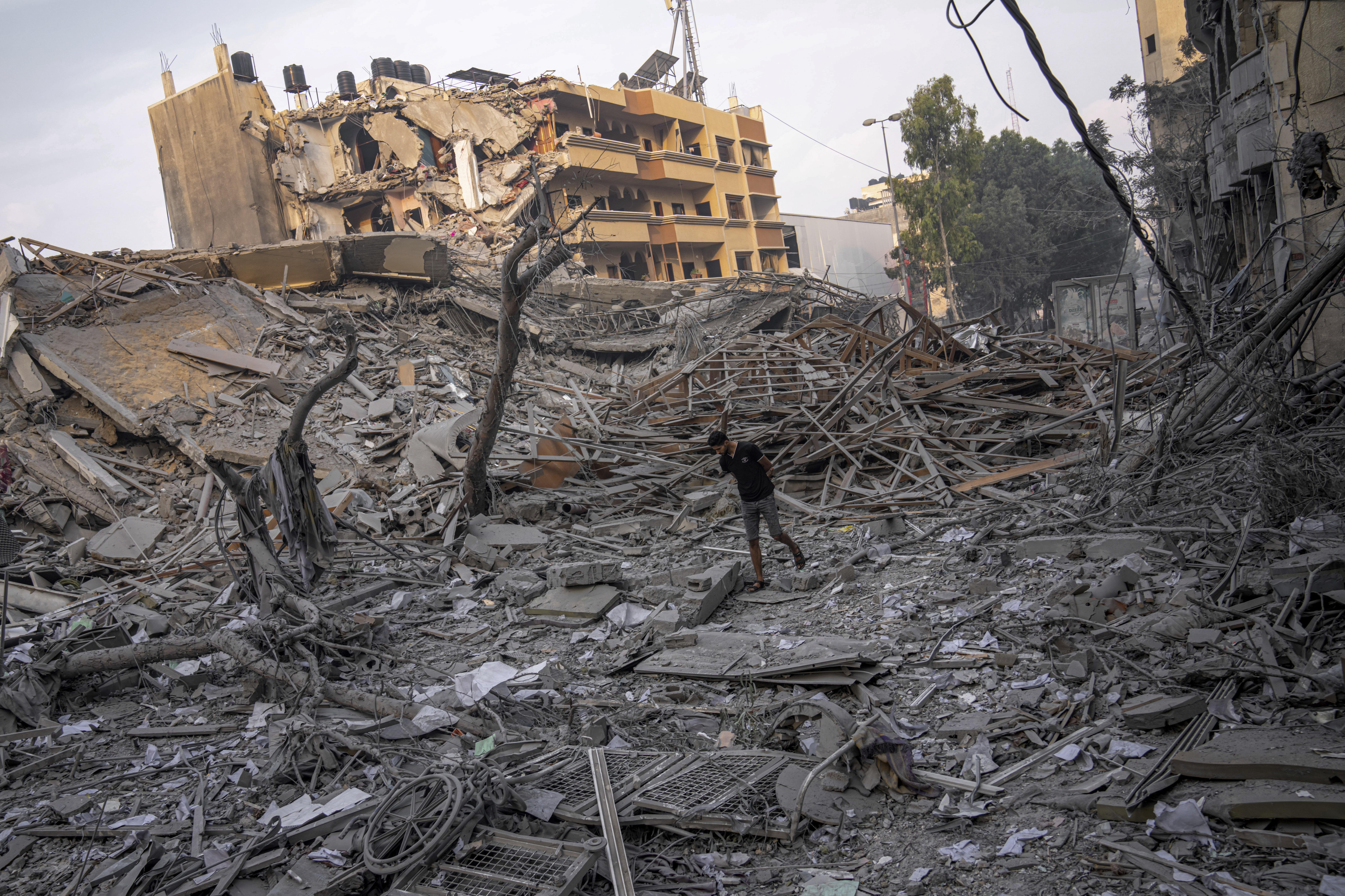 Palestinians inspect the rubble of a building after it was struck by an Israeli airstrike, in Gaza City