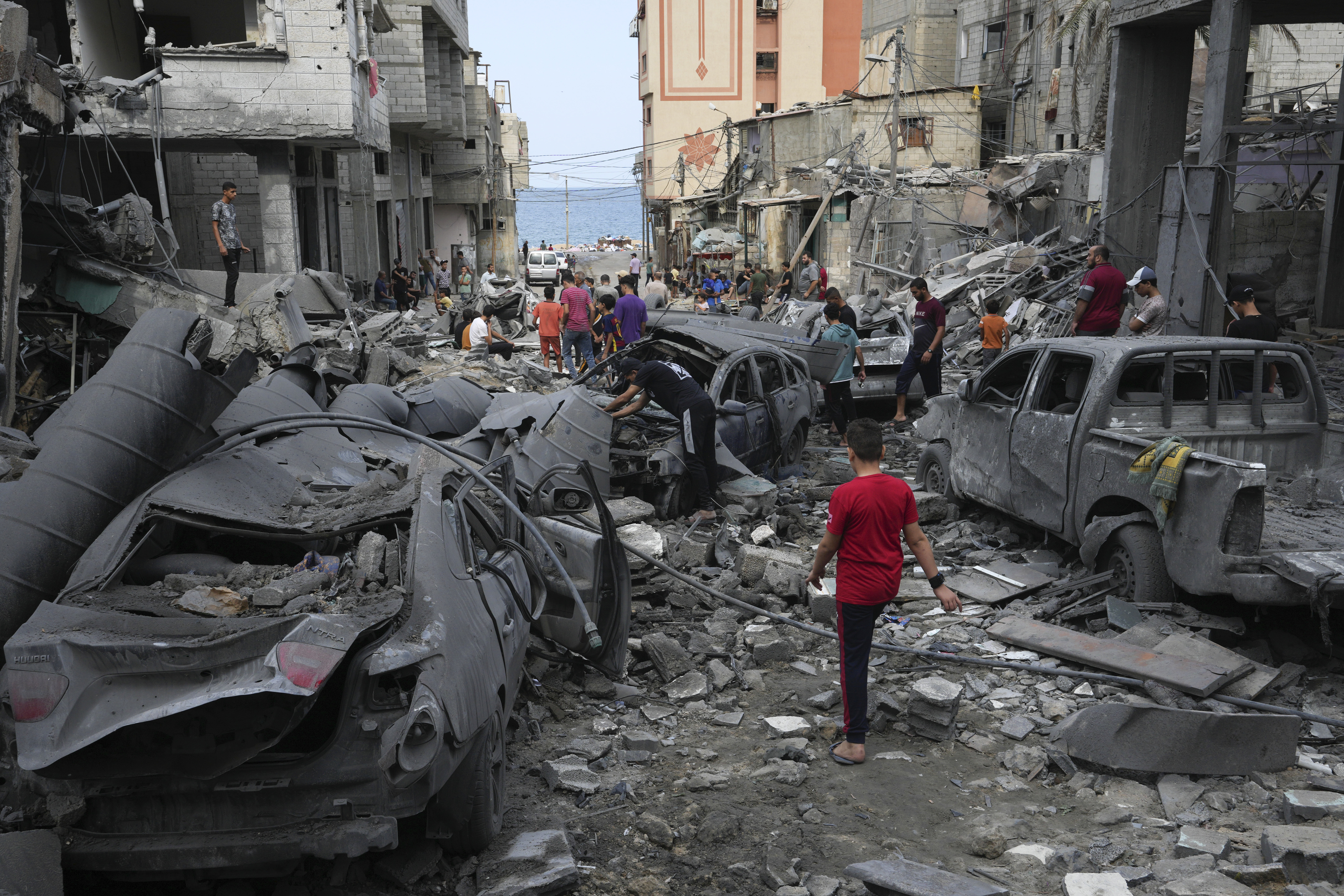 Palestinians inspect the rubble of the West mosque destroyed after it was hit by an Israeli airstrike at Shati refugee camp in Gaza City