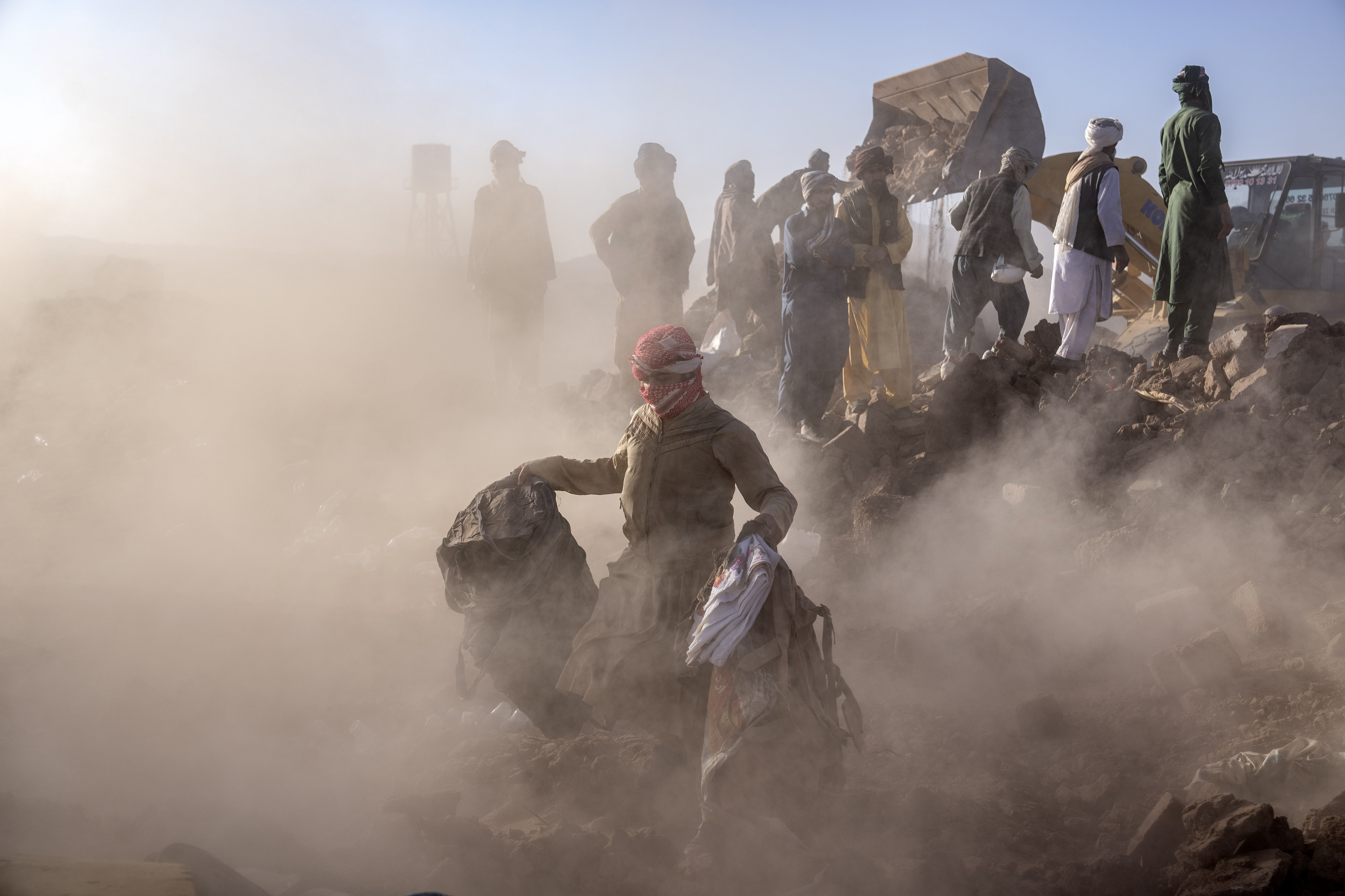 Afghan men search for victims after an earthquake in Zenda Jan district in Herat province, of western Afghanistan, October 9, 2023