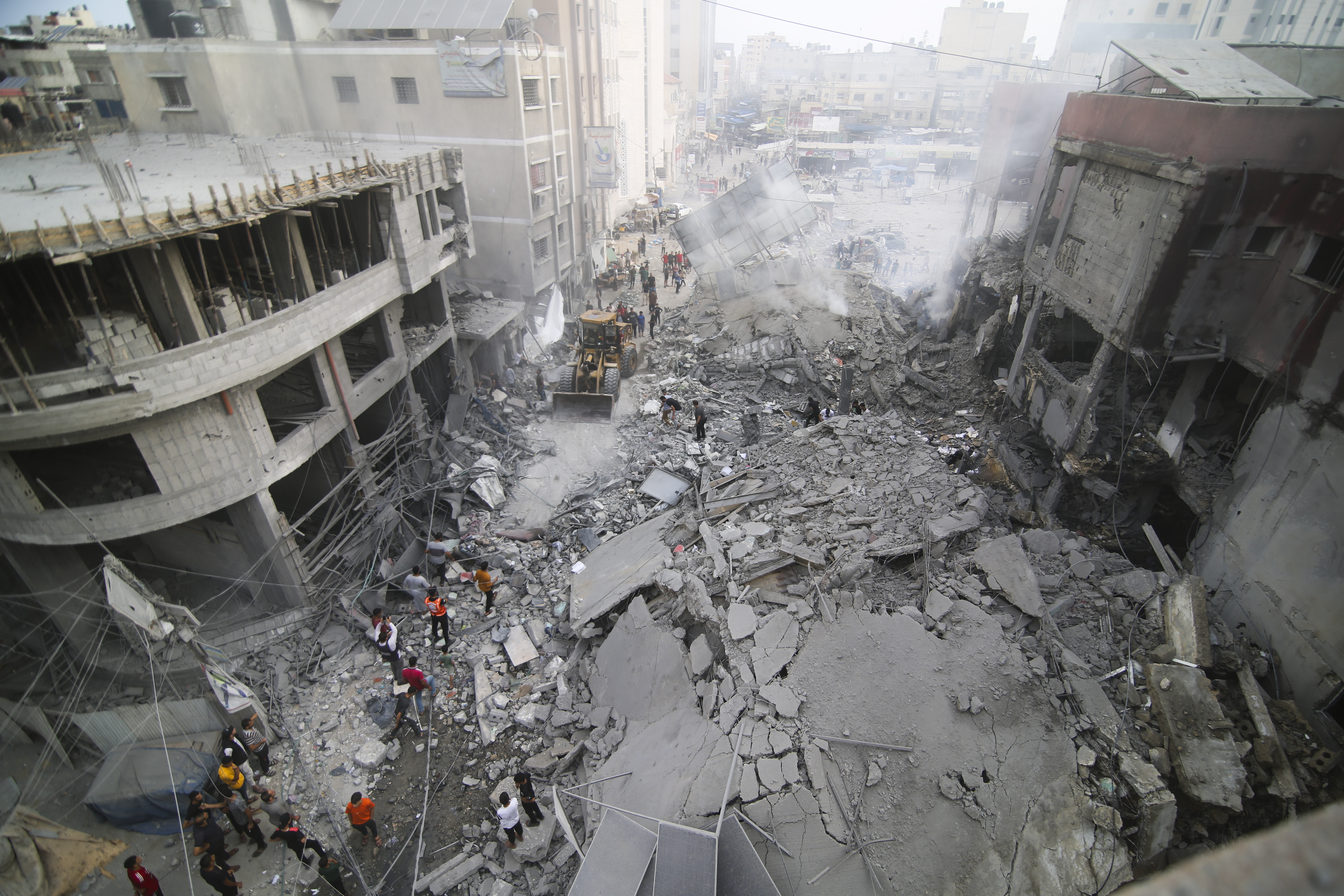 Palestinians inspect the damage of destroyed building after Israeli airstrikes in Khan Younis