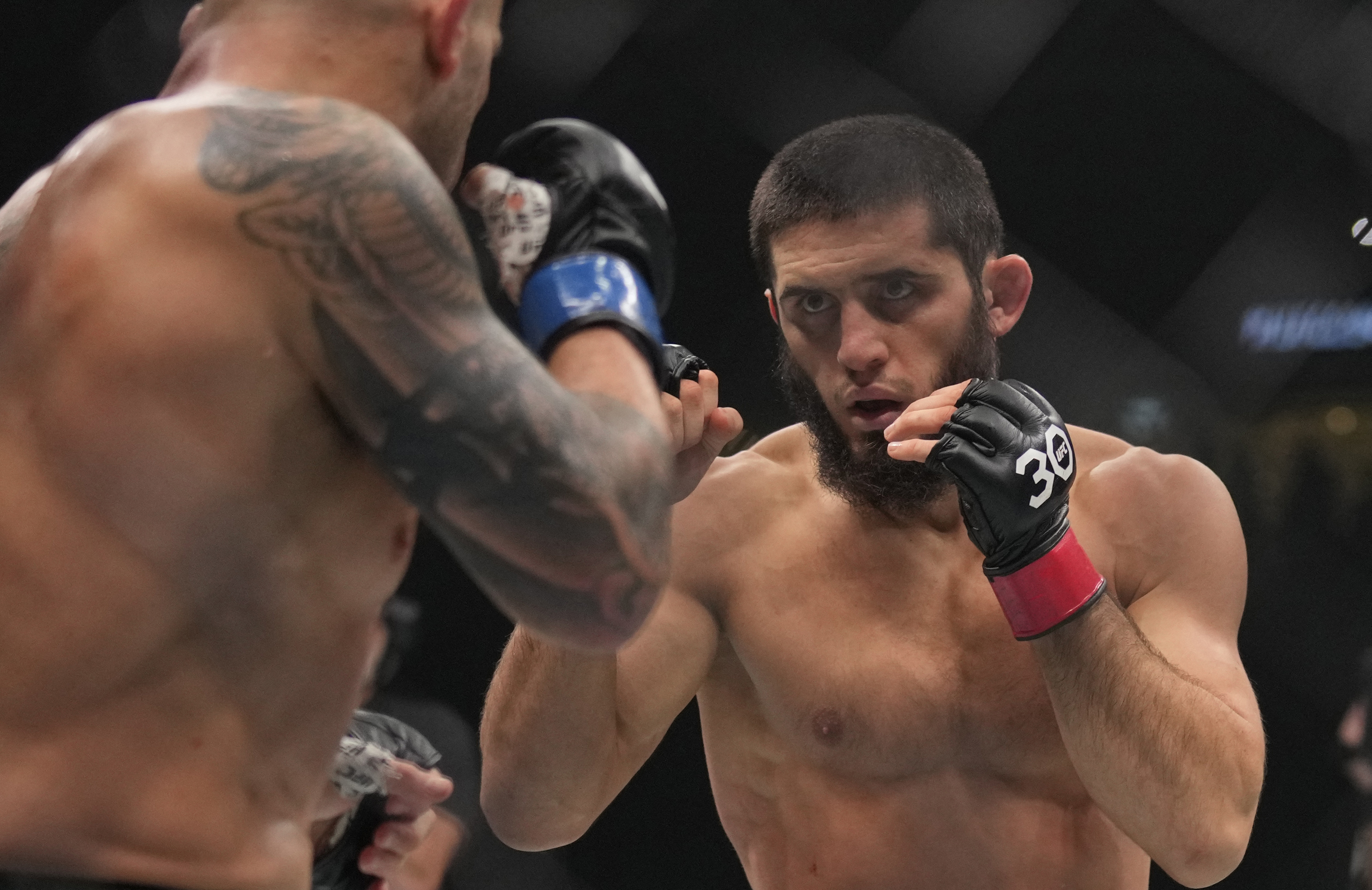 Islam Makhachev of Russia, right, battles Alex Volkanovski