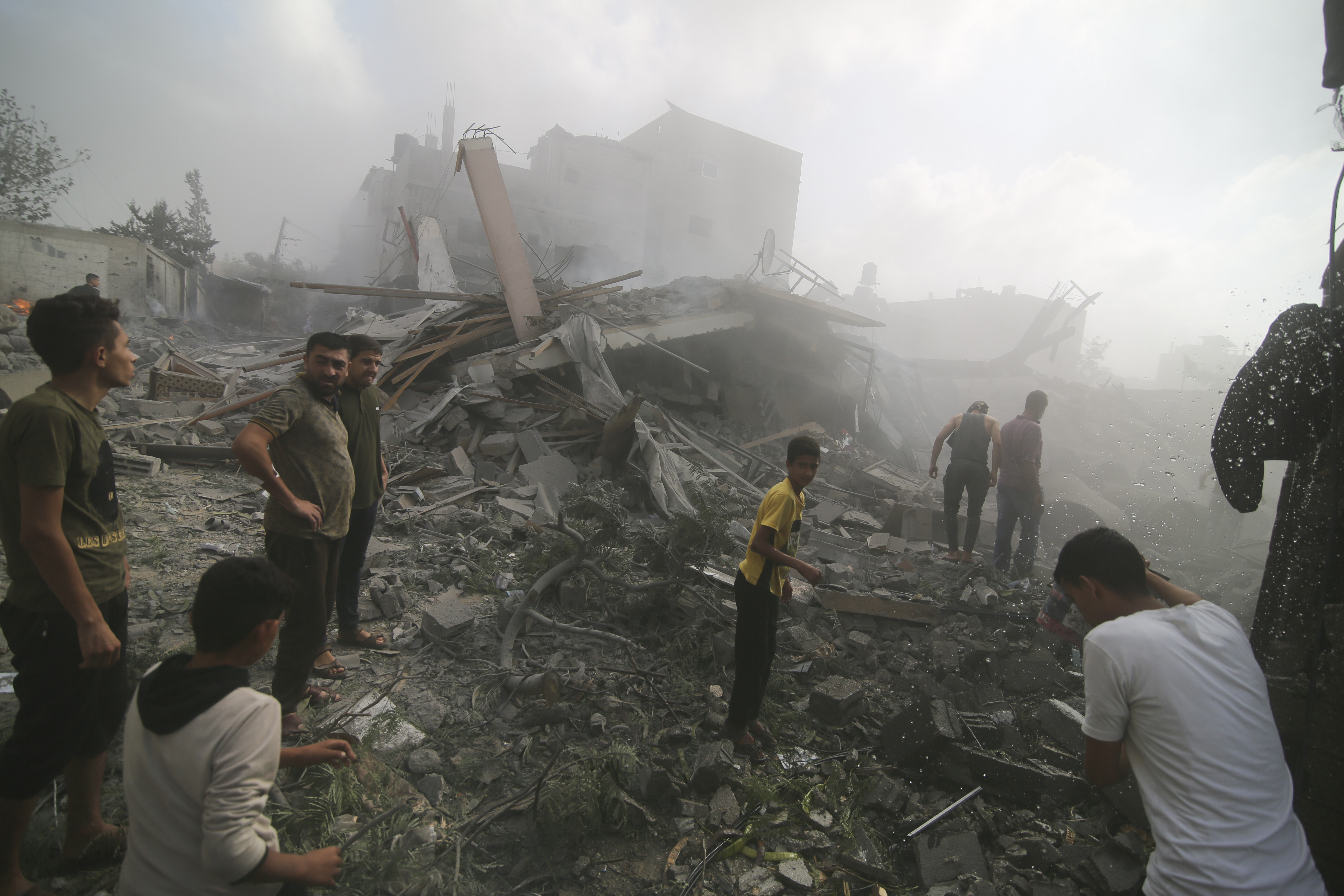 Palestinians look for survivers in buildings destroyed in the Israeli bombardment of the Gaza Strip in Rafah