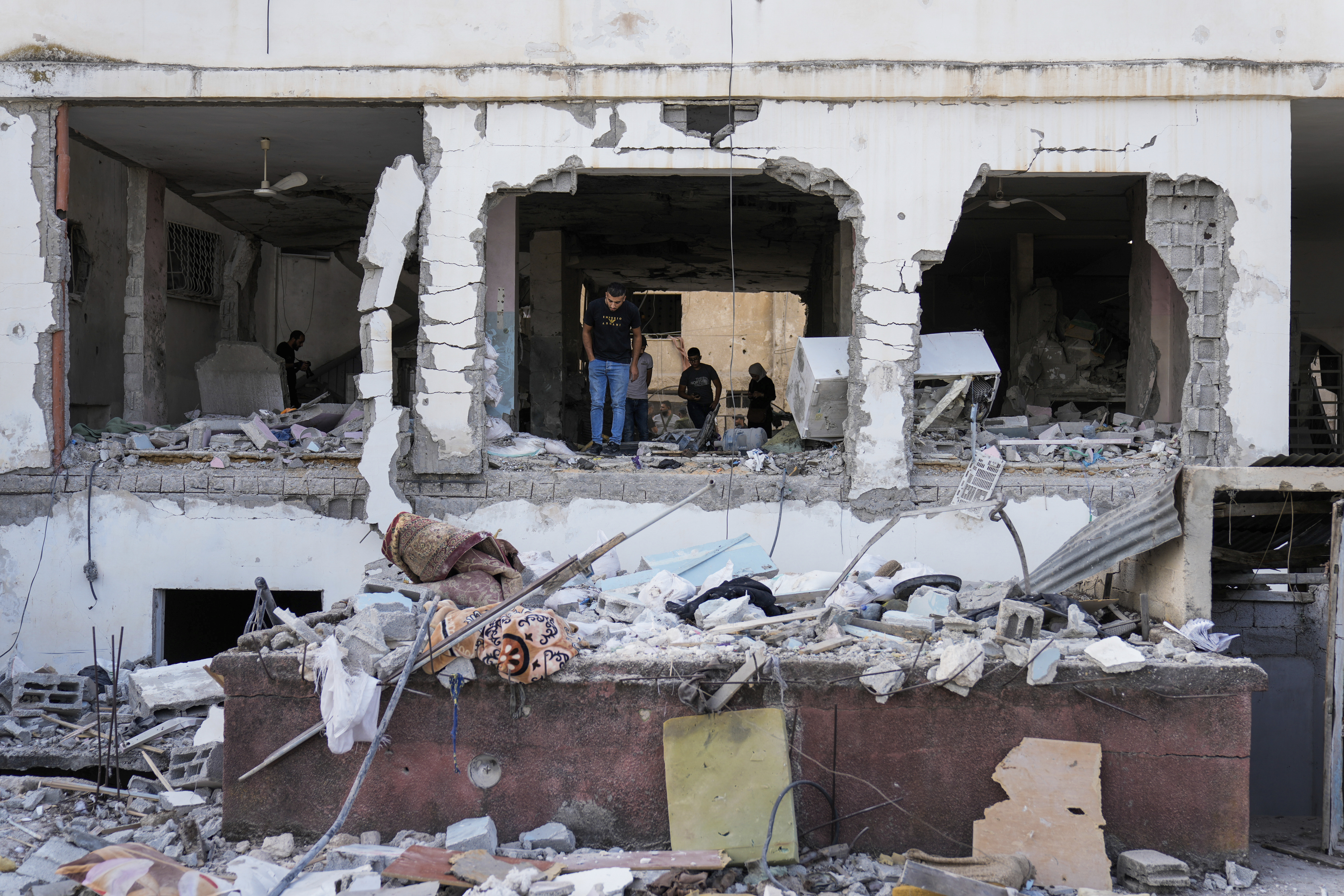 Palestinians inspect the damage after an Israeli strike hit a compound beneath a mosque in Jenin refugee camp, West Bank, Sunday