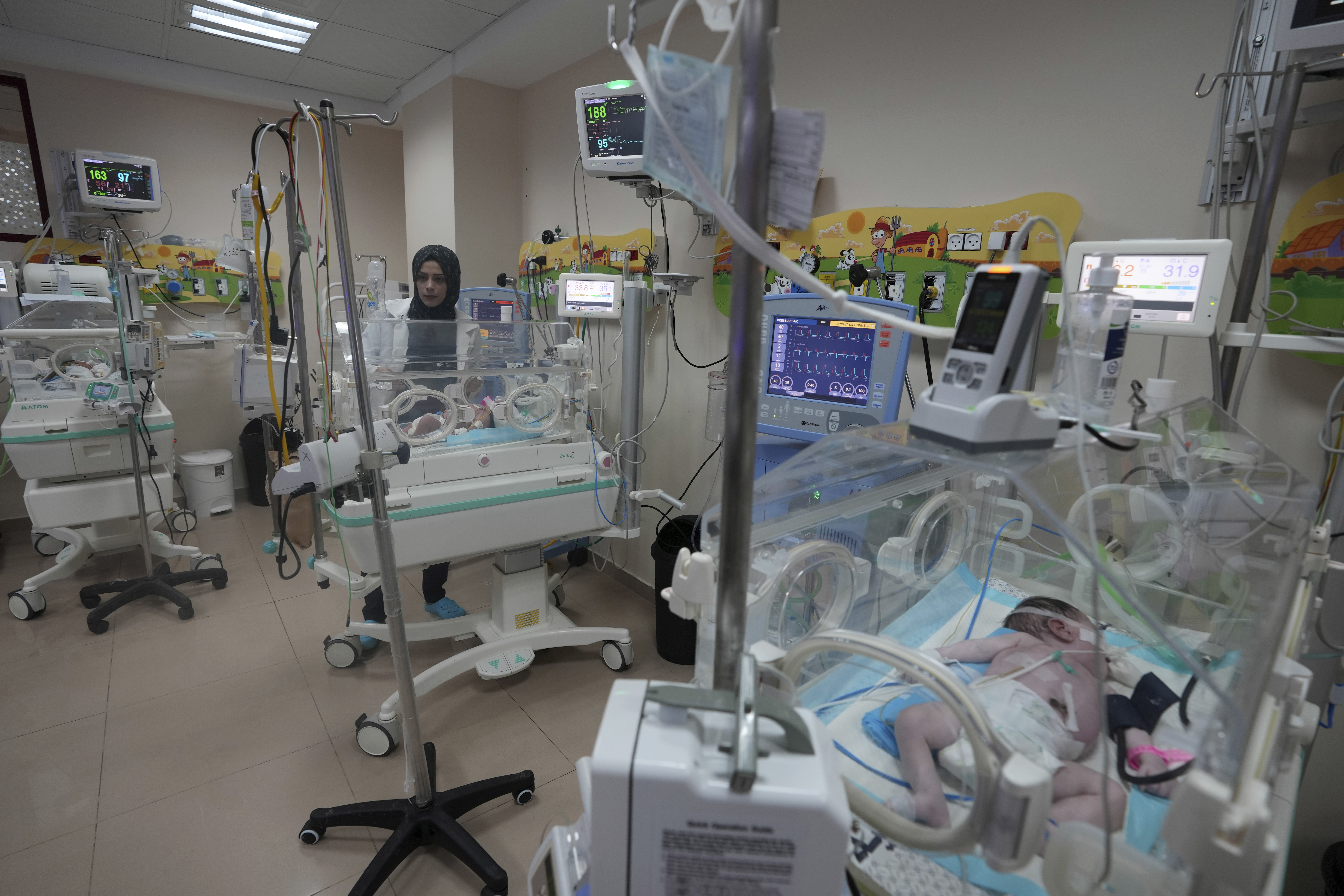Palestinian doctors treat a prematurely born baby at Al Aqsa Hospital in Deir el-Balah, Gaza Strip, Sunday, Oct. 22, 2023. (AP Photo/Adel Hana)