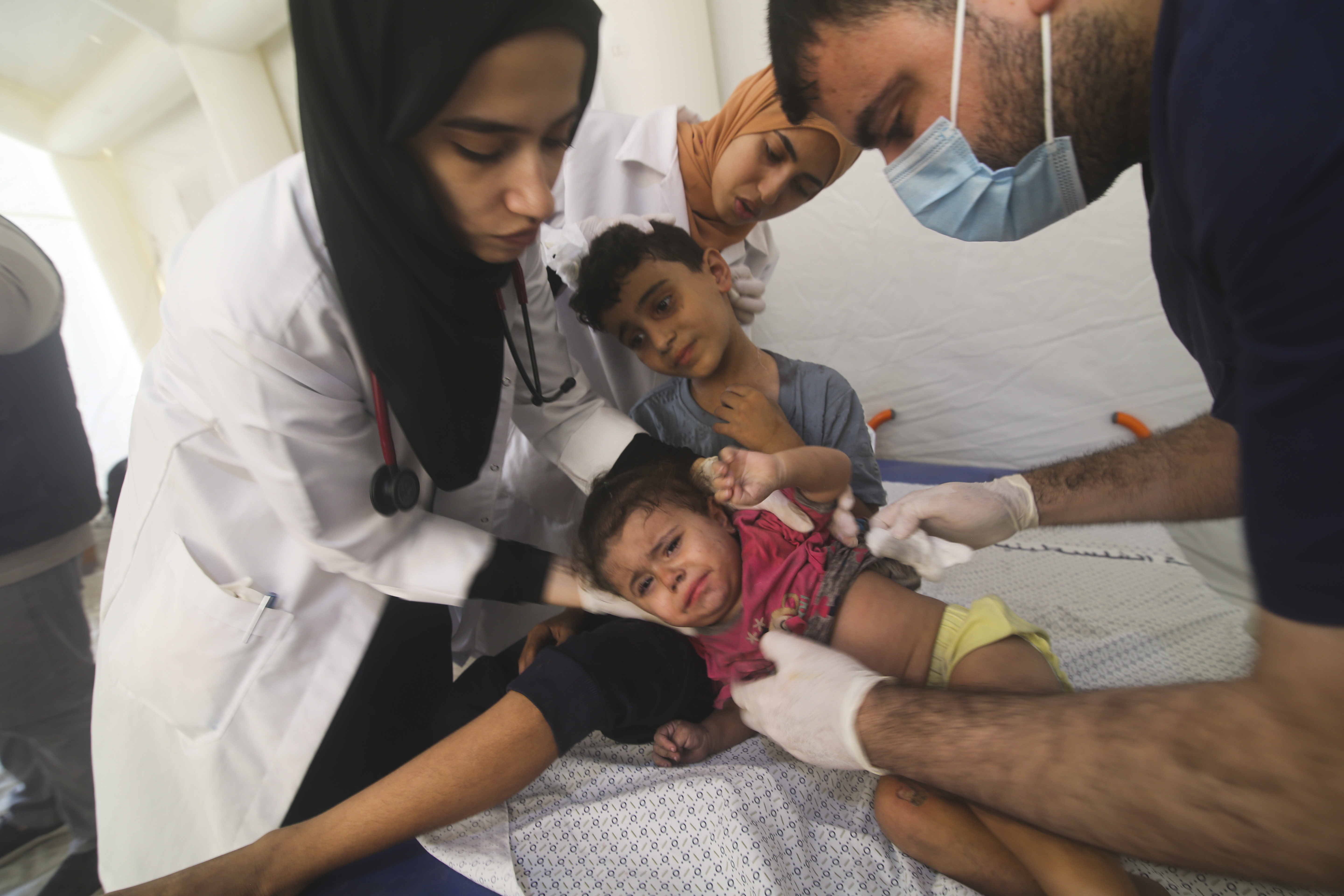 Palestinian children injured in the Israeli bombardment of the Gaza Strip are treated in a hospital in Rafah on Monday, Oct. 23, 2023. (AP Photo/Hatem Ali)